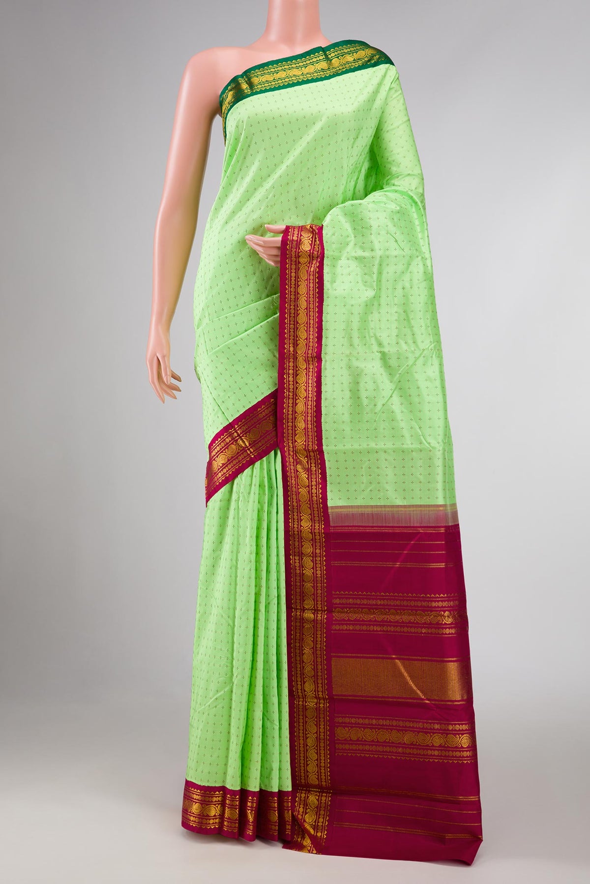 Pure Silk Pure Zari Parrot Green Dual Tone Kanchipuram Saree with Thread Butta on the body and Ganga Jamuna Border displayed on a mannequin
