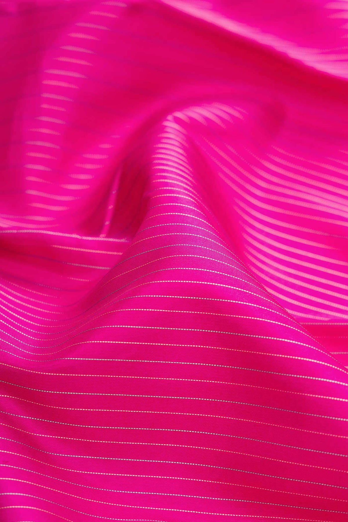 Close up of Pink Dual Tone Kanjivaram Silk Saree with Stripes on the body and Ganga Jamuna Border.  displaying folds