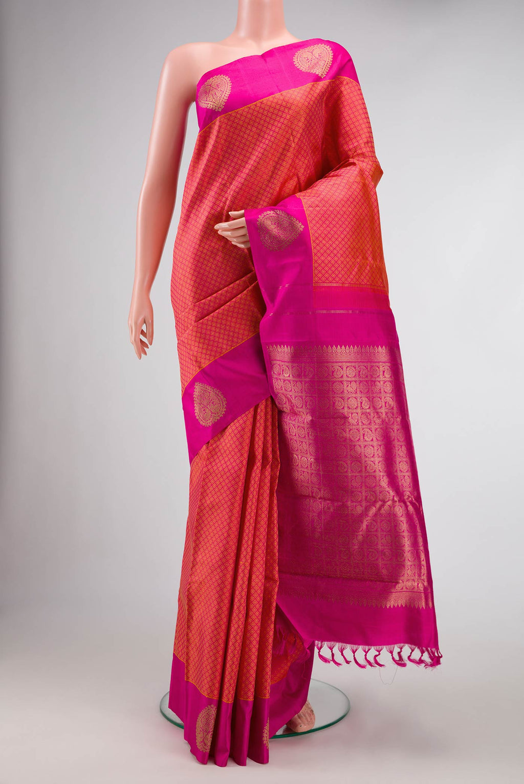 Orange Dual Tone Kanjivaram Silk Saree with Jacquard design on the body and Fancy Border.  displayed on a mannequin