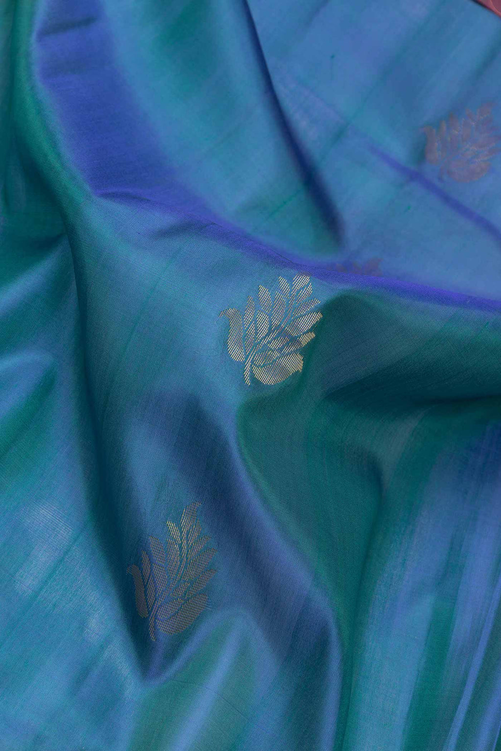 Close up of Peacock Blue Dual Tone Soft Silk Saree with Zari Butta on the body and Zari Border.  displaying folds