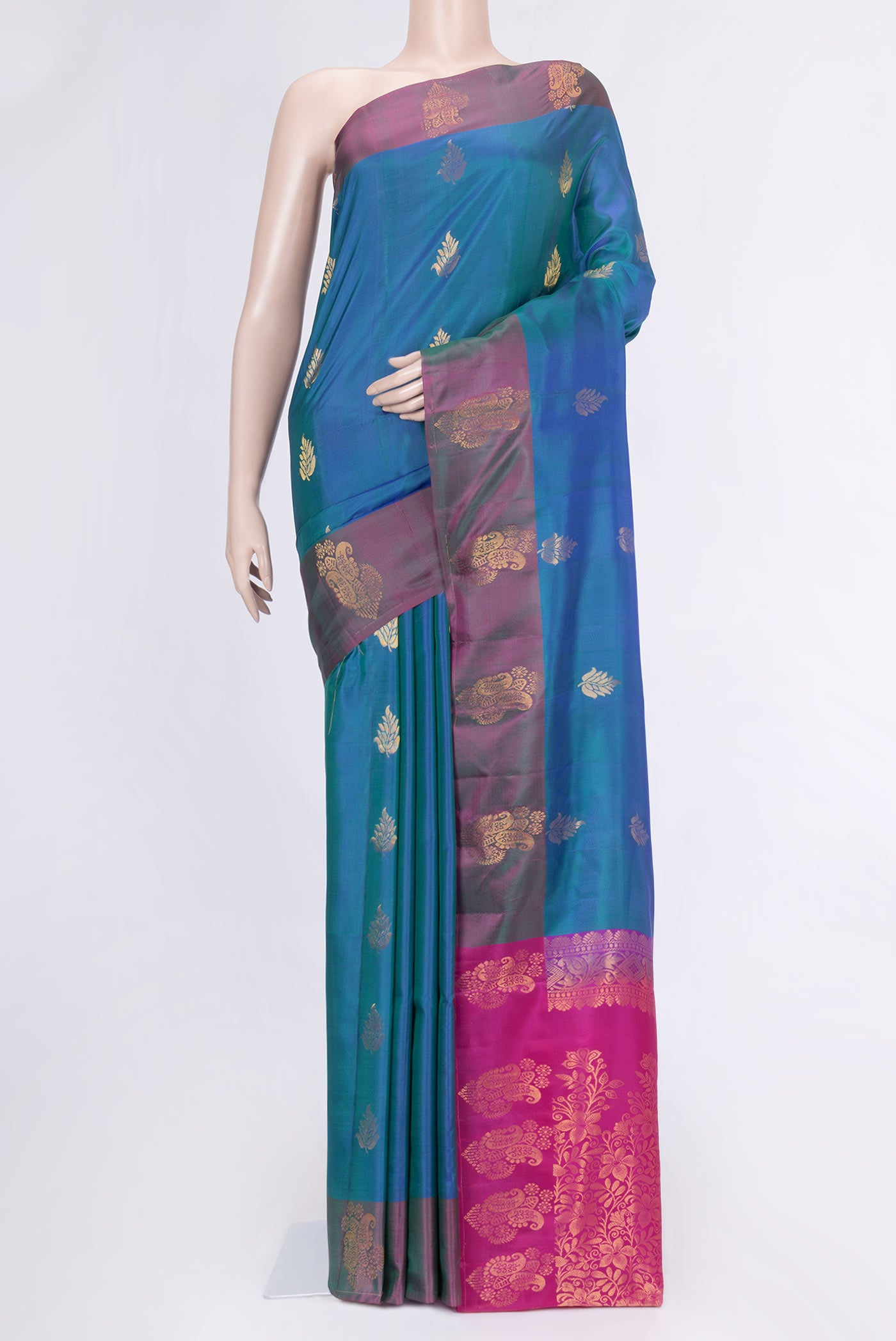Peacock Blue Dual Tone Soft Silk Saree with Zari Butta on the body and Zari Border.  displayed on a mannequin