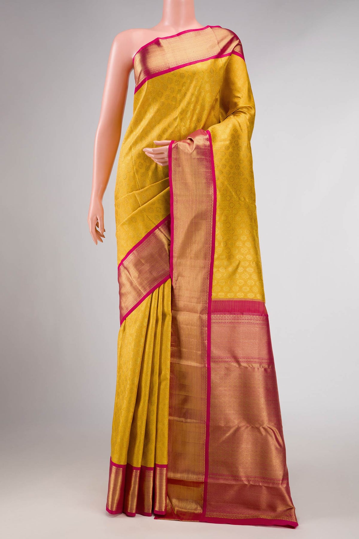 Pure Silk Pure Zari Yellow Dual Tone Kanchipuram Saree with Zari Brocade on the body and Zari Border displayed on a mannequin