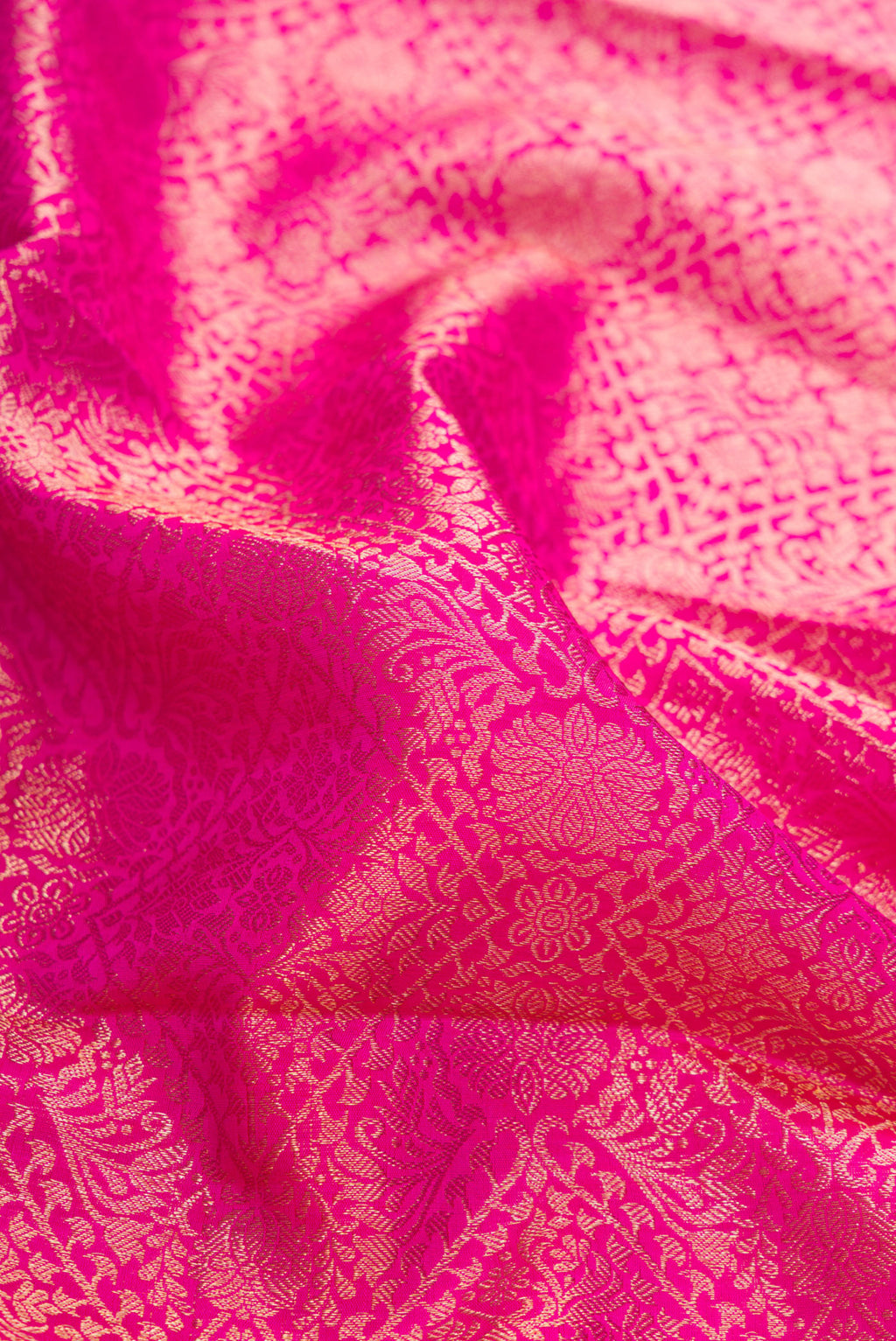 Close up of Pink Dual Tone Kanchipuram Silk Saree with Zari Brocade on the body and Zari Border.  displaying folds