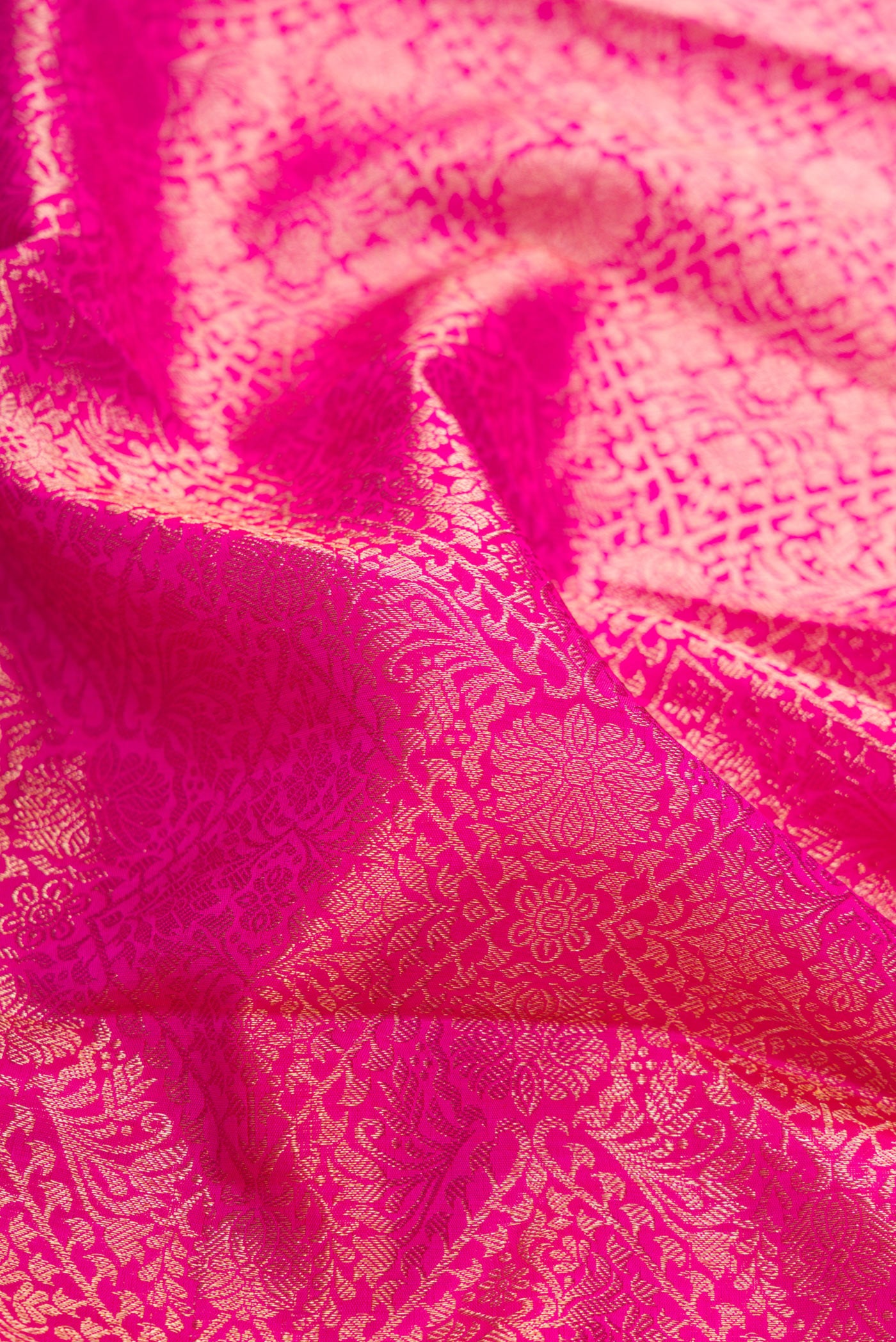 Close up of Pink Dual Tone Kanchipuram Silk Saree with Zari Brocade on the body and Zari Border.  displaying folds