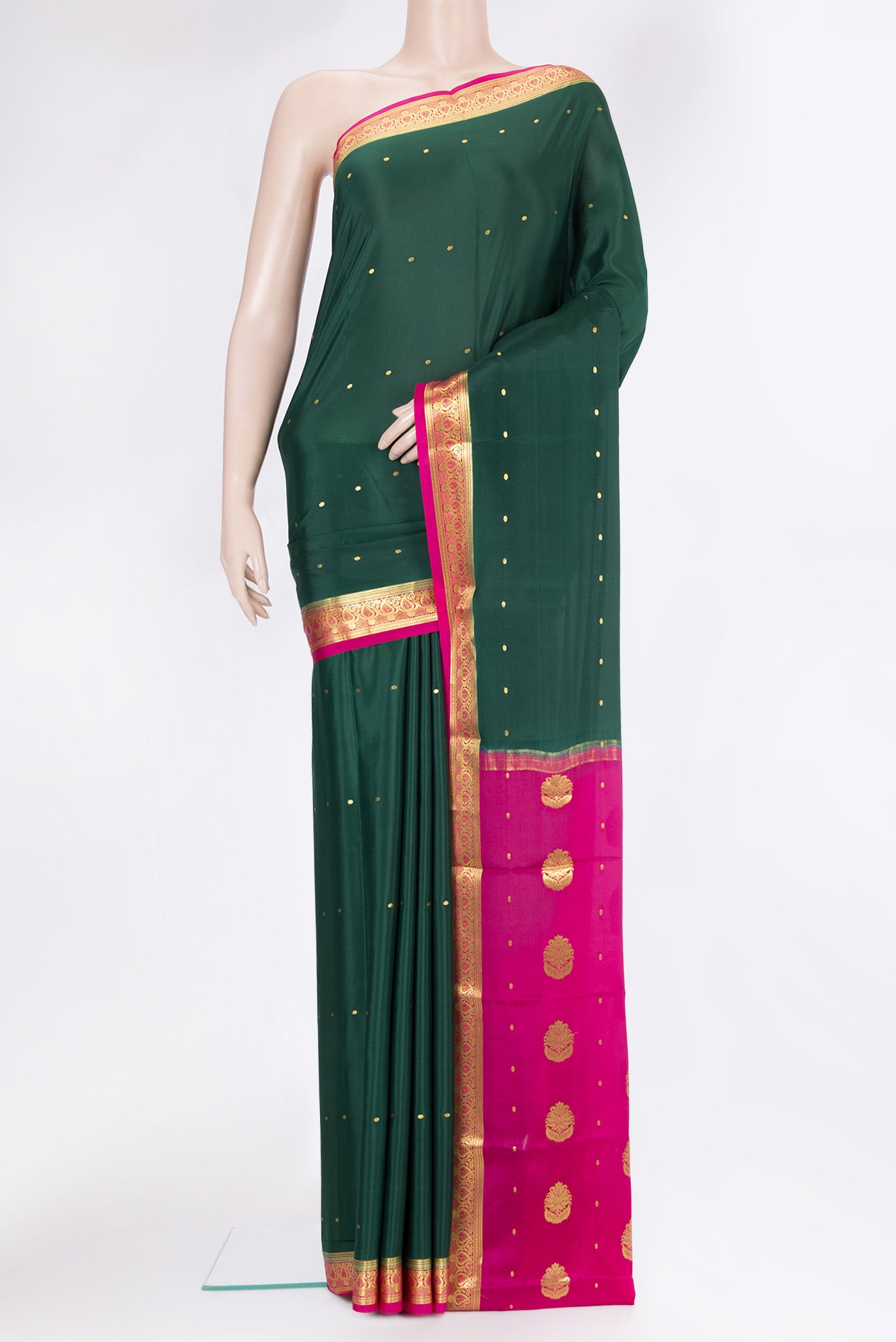 Bottle Green Mysore Silk Saree with Zari Butta on the body and Zari Border.  displayed on a mannequin