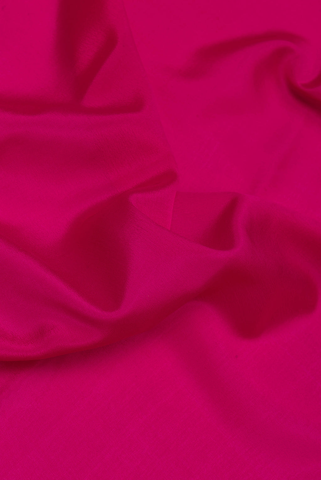 Close up of Magenta Mysore Silk Saree with Plain Body and Zari Border.  displaying folds