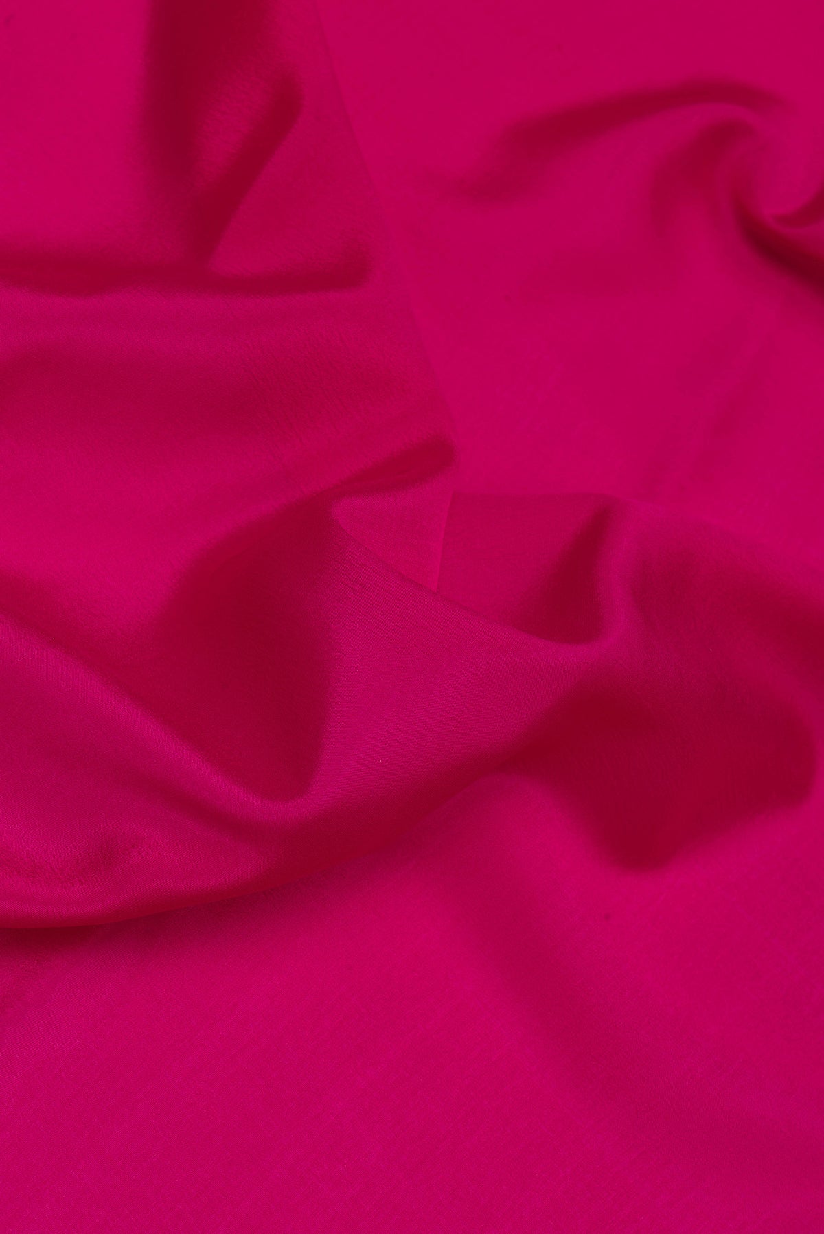 Close up of Magenta Mysore Silk Saree with Plain Body and Zari Border.  displaying folds