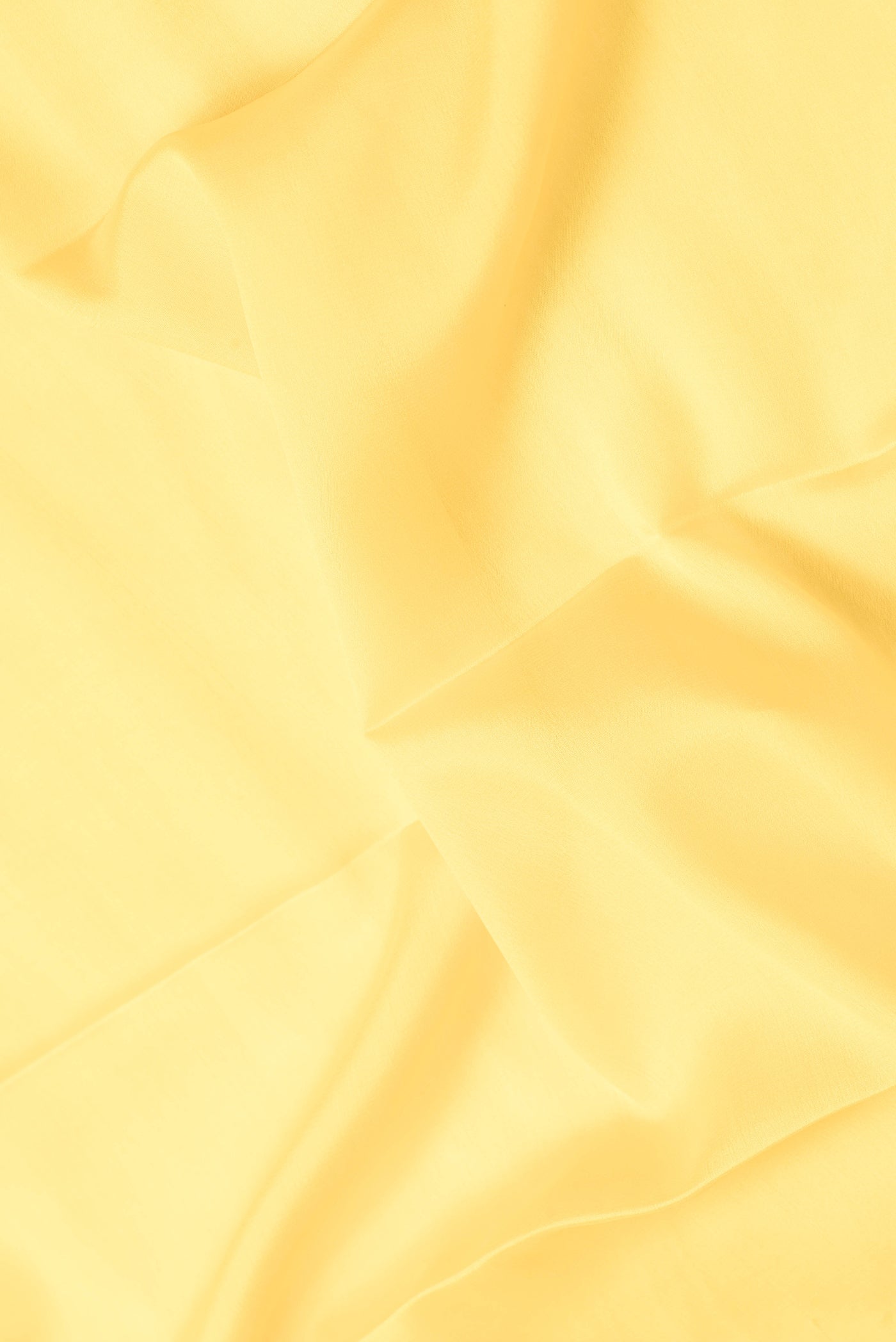 Close up of Yellow Dual Tone Mysore Silk Saree with Plain Body and Zari Border.  displaying folds