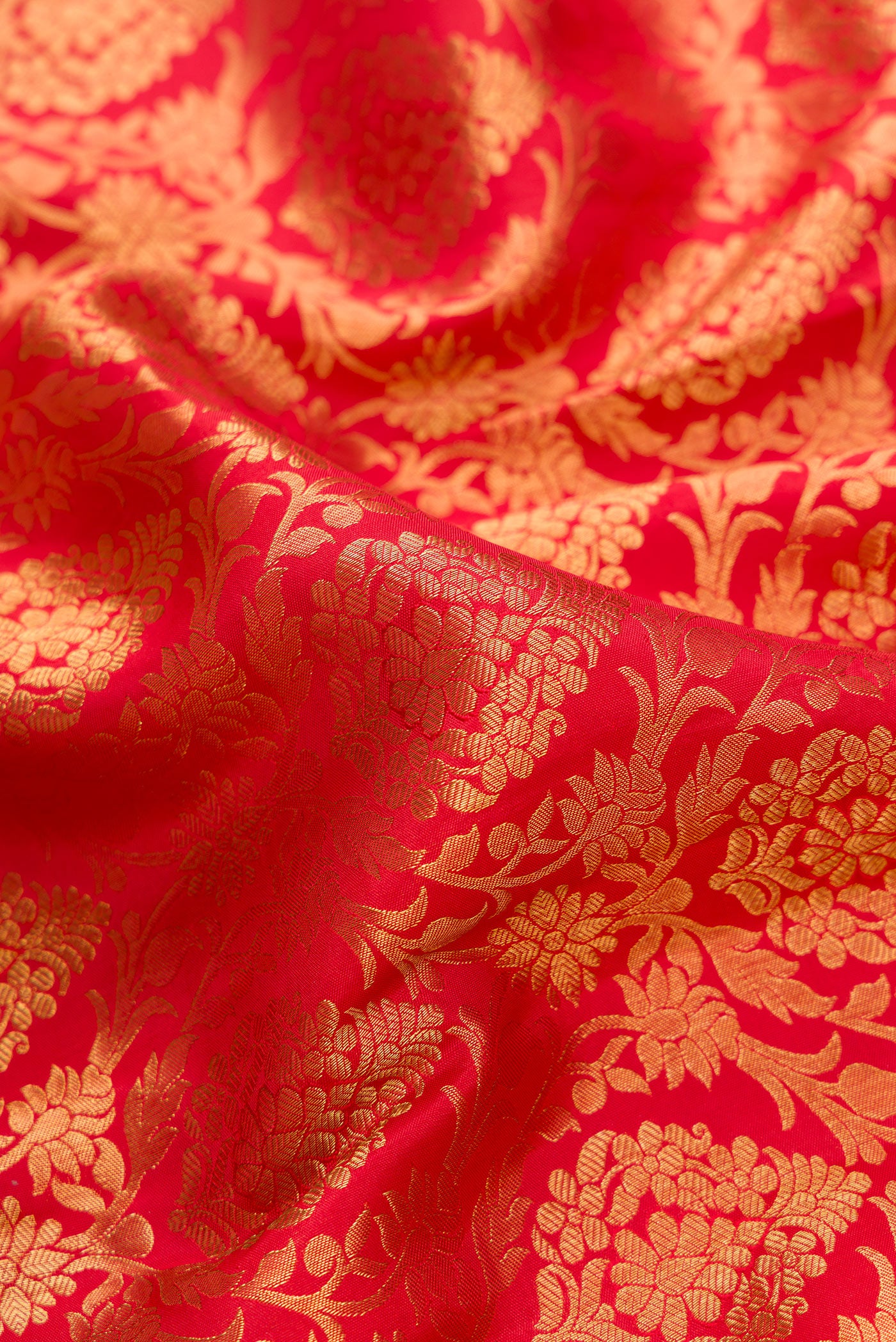 Close up of Red Dual Tone Kanjivaram Silk Saree with Zari Brocade on the body and Zari Border.  displaying folds