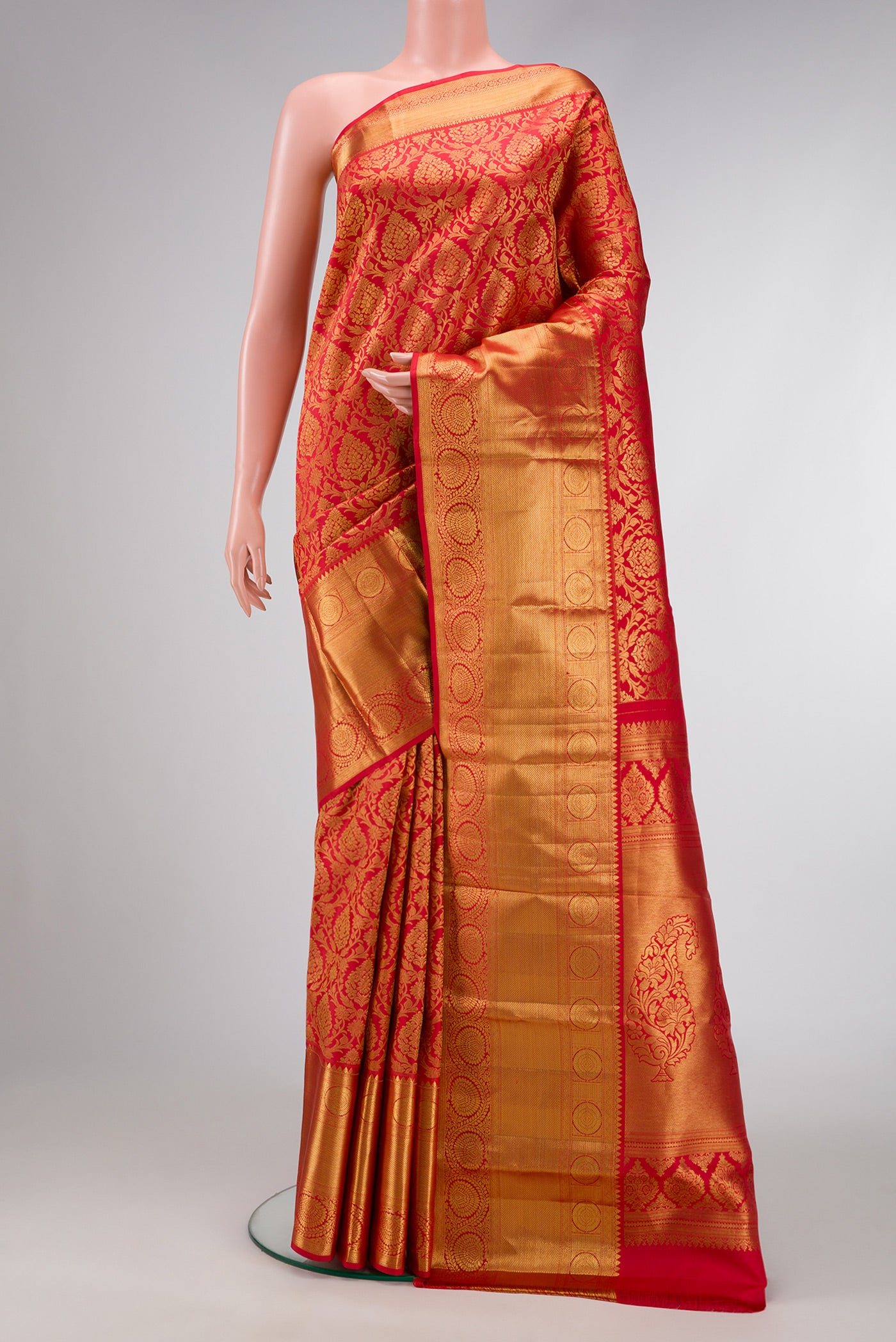 Red Dual Tone Kanjivaram Silk Saree with Zari Brocade on the body and Zari Border.  displayed on a mannequin