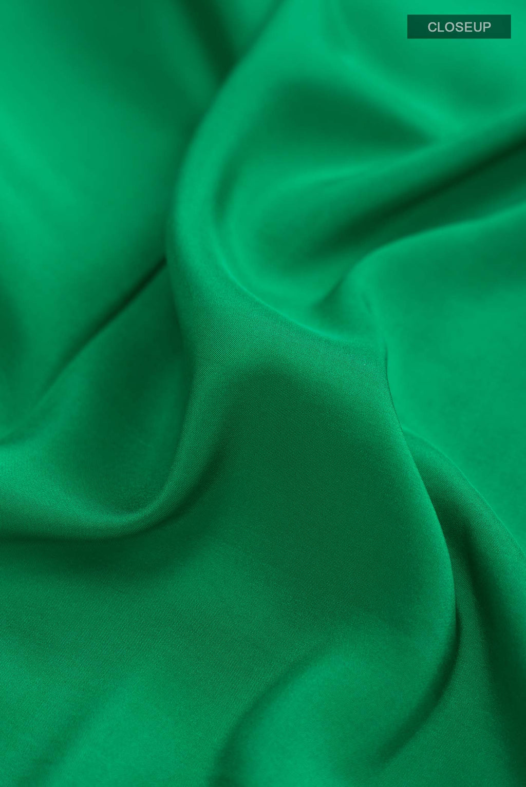 Close up of Pure Silk Pure Zari Green Mysore Crepe Saree with Plain Body and Zari Border displaying folds