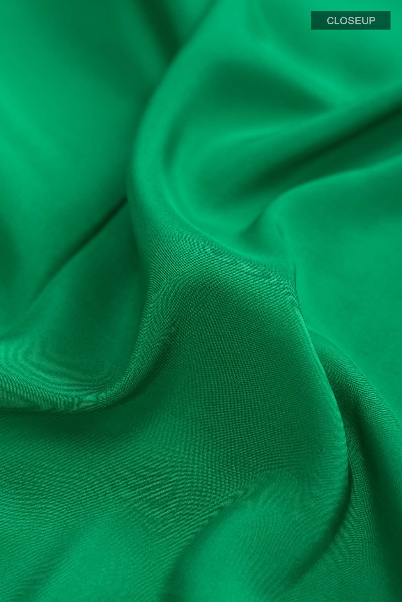 Close up of Pure Silk Pure Zari Green Mysore Crepe Saree with Plain Body and Zari Border displaying folds
