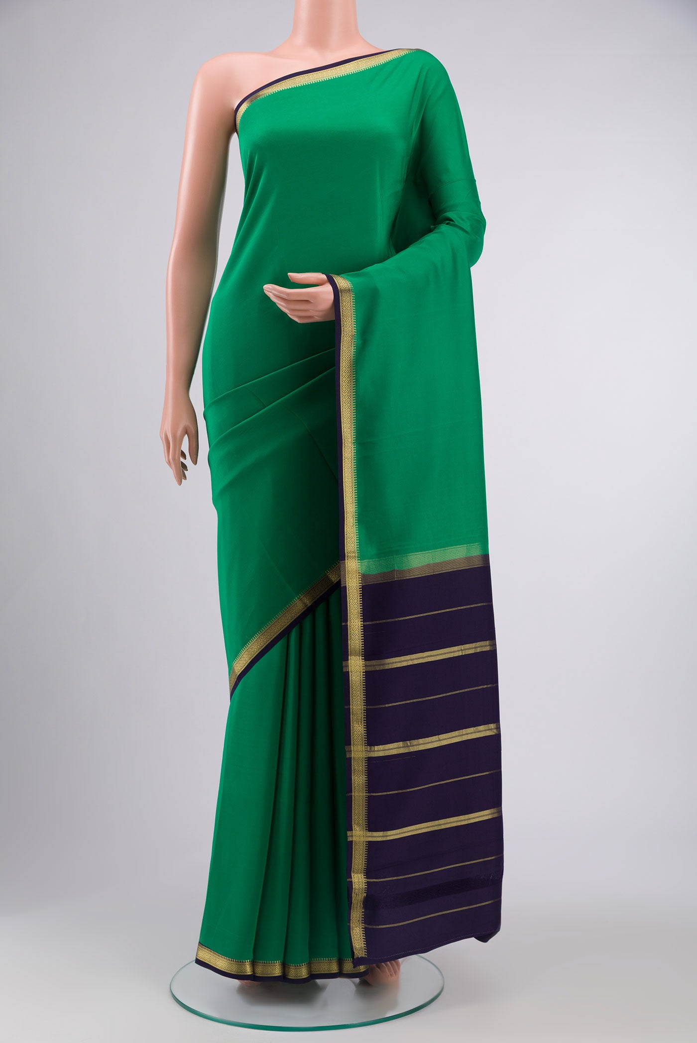 Pure Silk Pure Zari Green Mysore Crepe Saree with Plain Body and Zari Border displayed on a mannequin