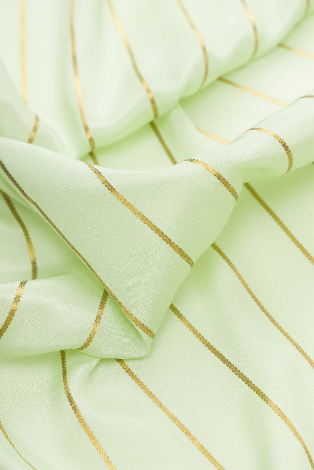 Close up of Pista Green Dual Tone Mysore Silk Saree with Stripes on the body and Fancy Border.  displaying folds