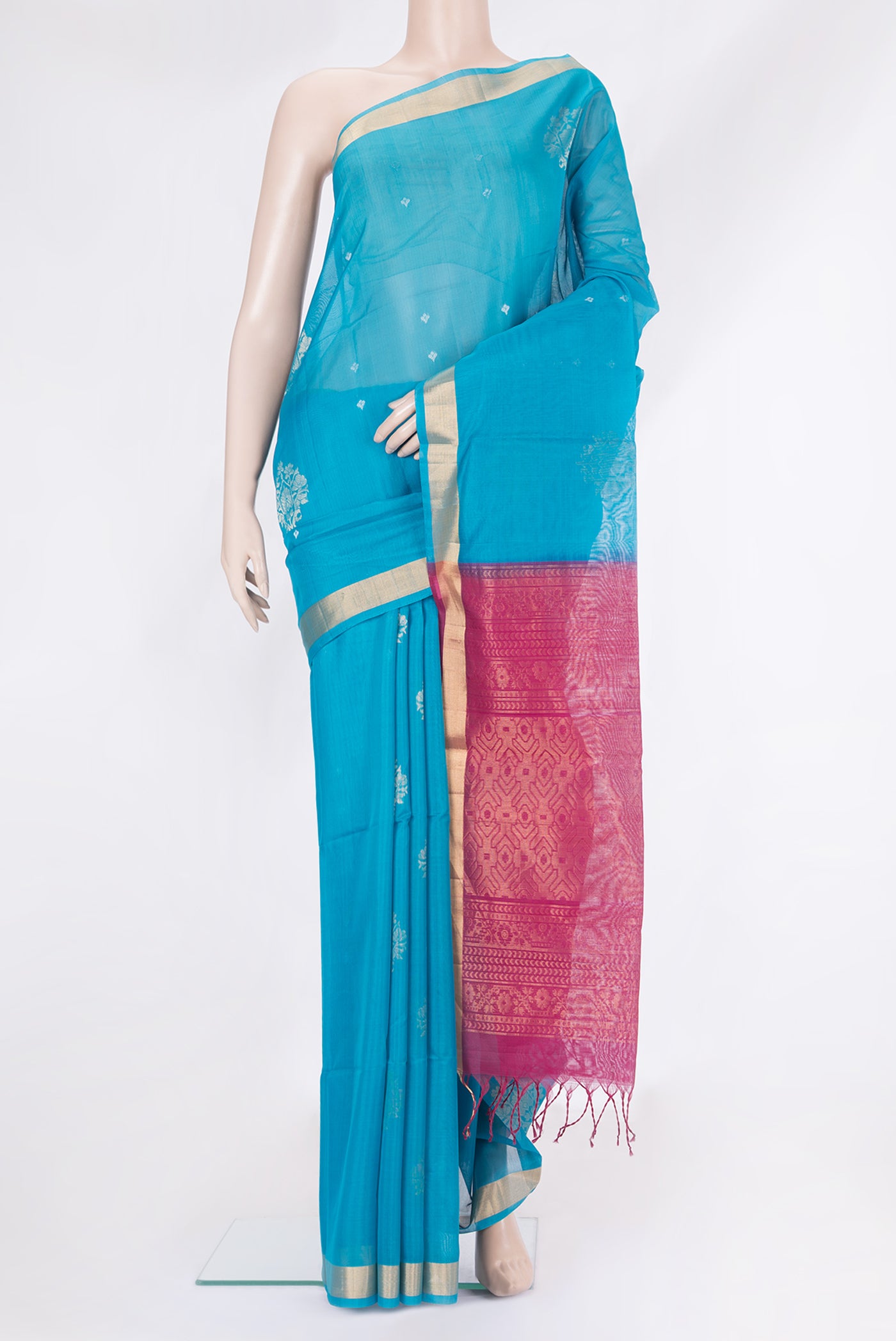 Sky Blue Silk Cotton Saree with Zari Butta on the body and Zari Border.  displayed on a mannequin
