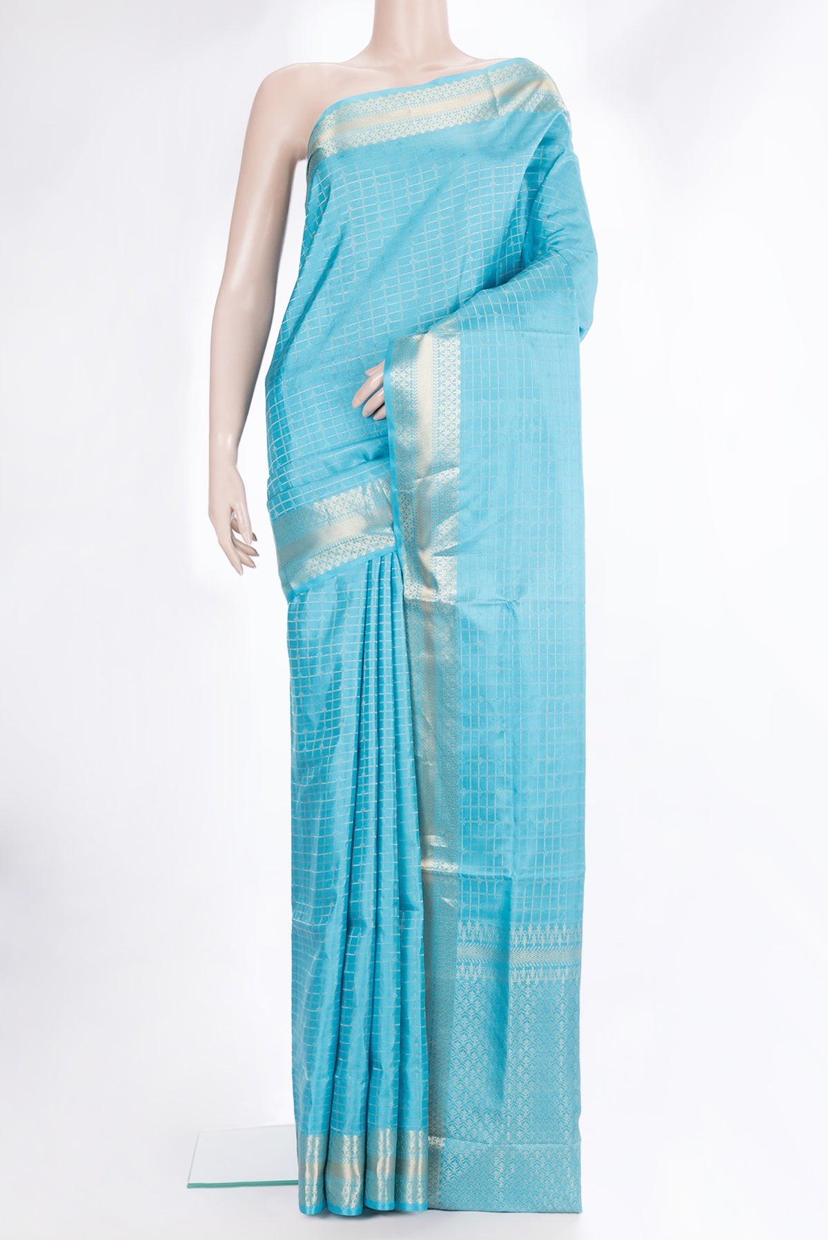 Pure Silk Sky Blue Soft Saree with Checked design on the body and Zari Border.  displayed on a mannequin