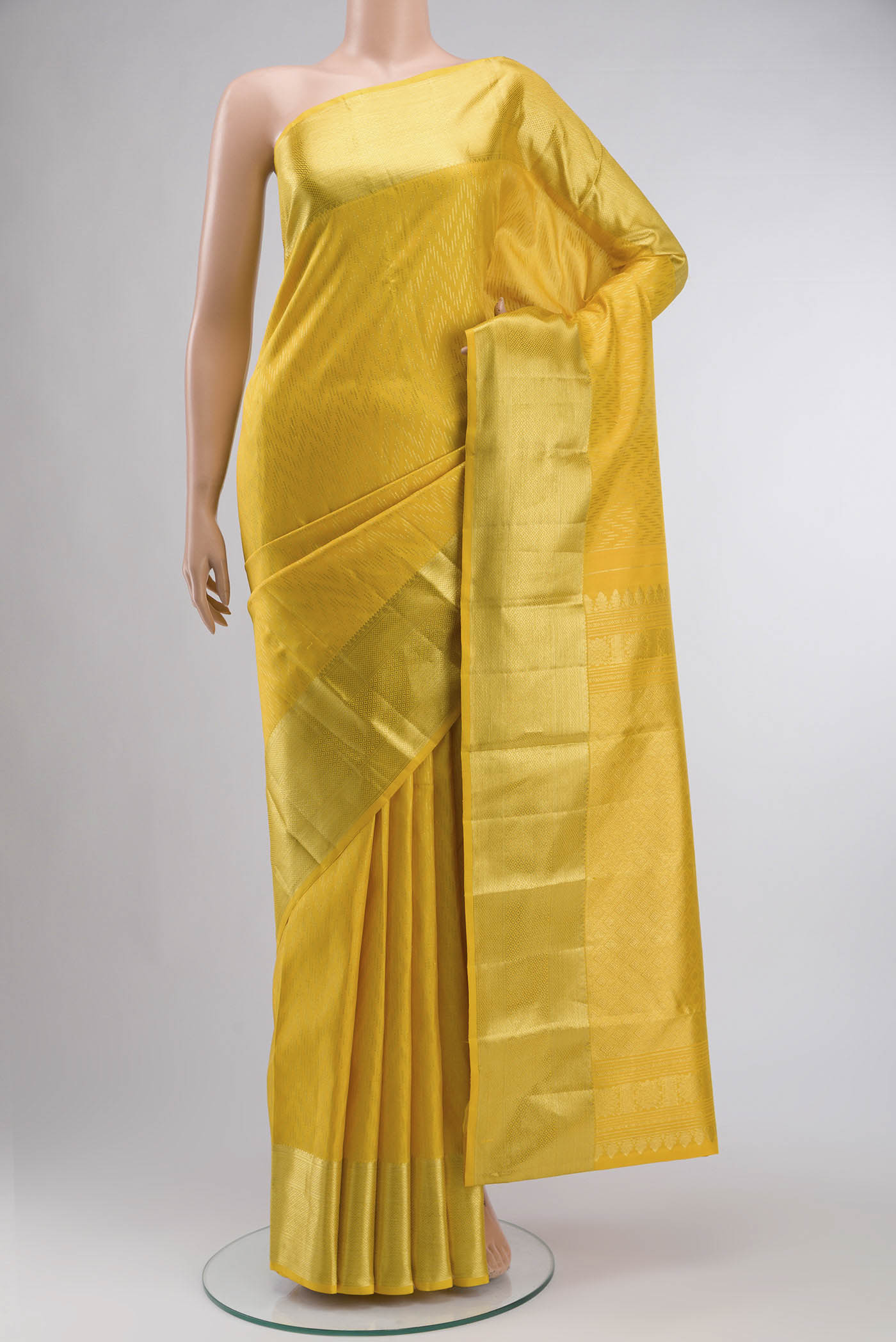 Yellow Kanchipuram Silk Saree with Stripes on the body and Zari Border displayed on a mannequin