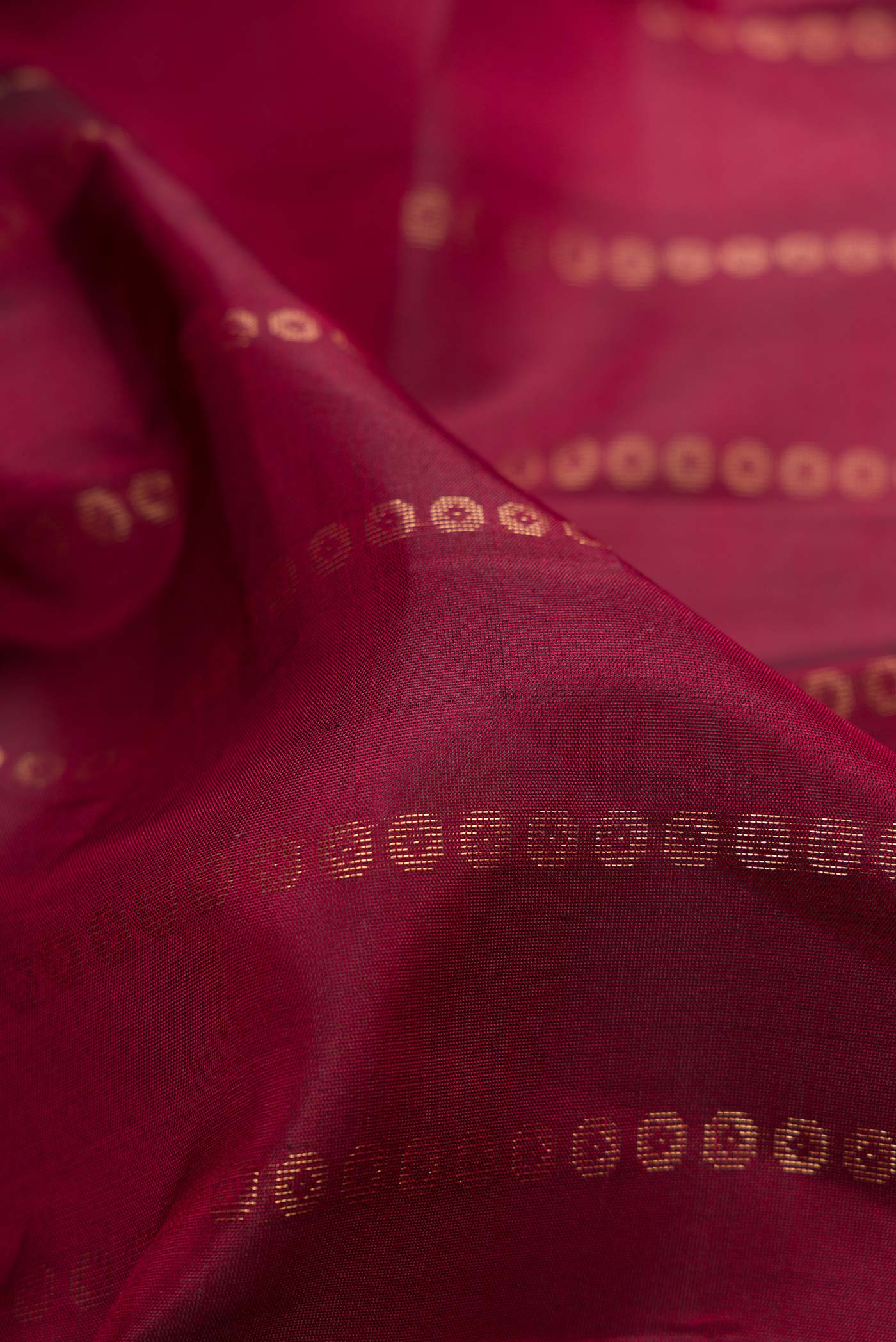 Close up of Maroon Dual Tone Kanjivaram Silk Saree with Stripes on the body and Zari Border.  displaying folds