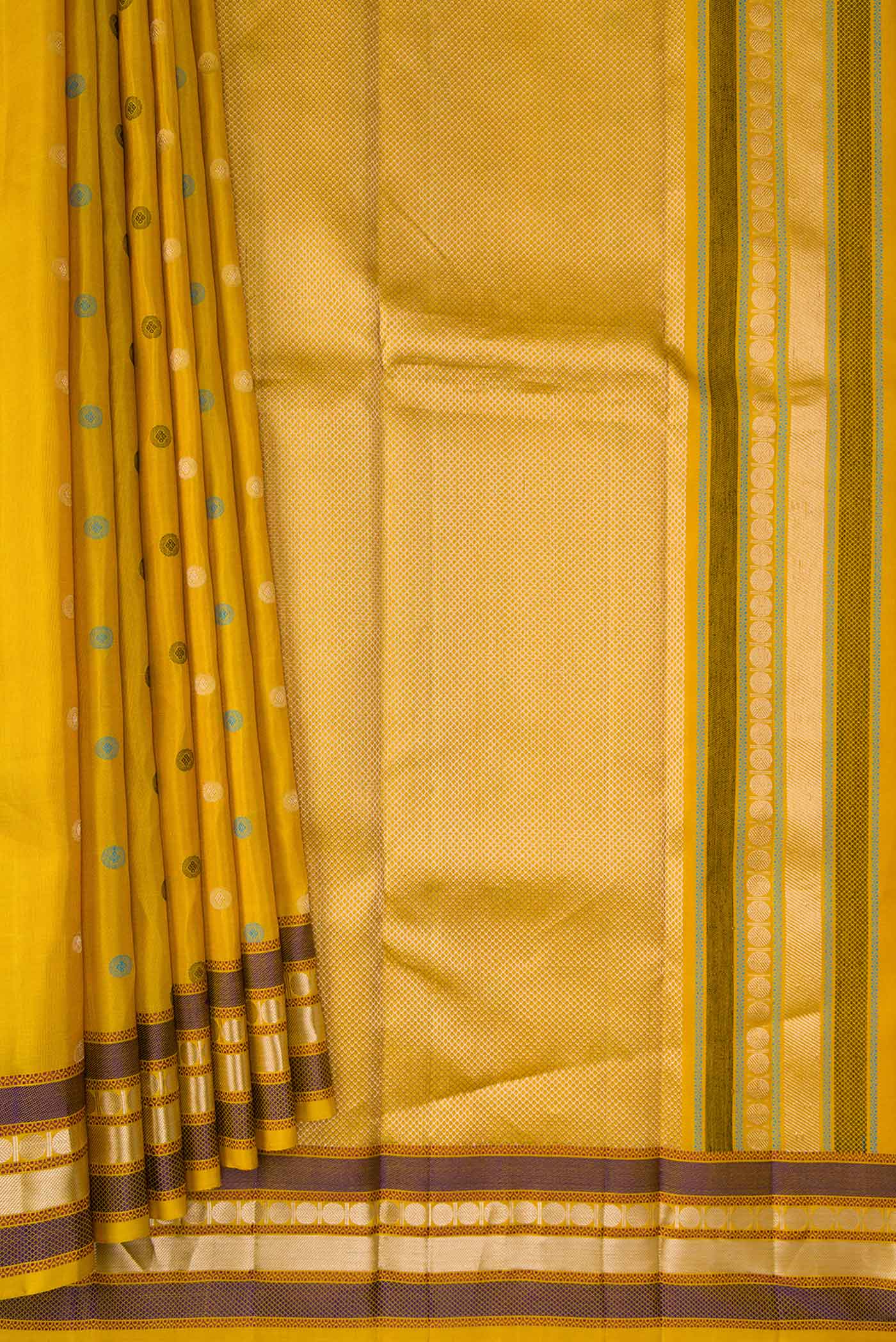 Pleats and pallu of Mustard Dual Tone Kanchipuram Silk Saree with Zari And Thread Butta on the body and Zari Border. 