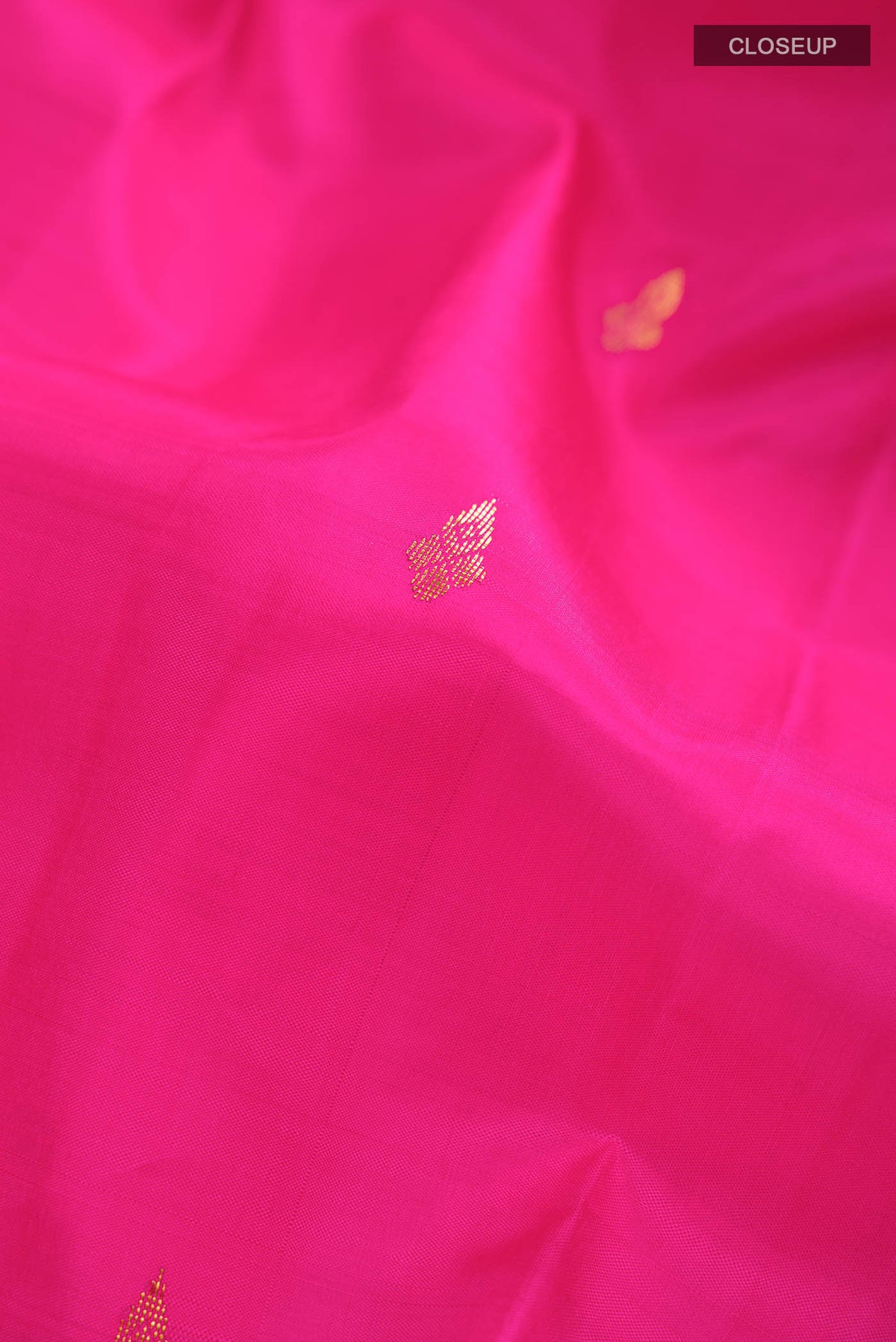 Close up of Pink Kanchipuram Silk Saree with Zari Butta on the body and One Side Border displaying folds