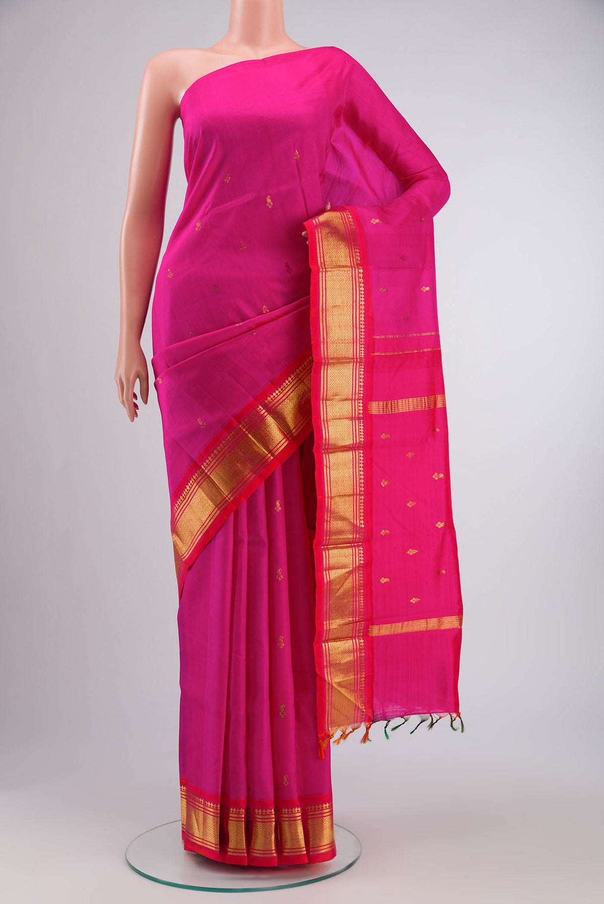 Pink Kanchipuram Silk Saree with Zari Butta on the body and One Side Border displayed on a mannequin