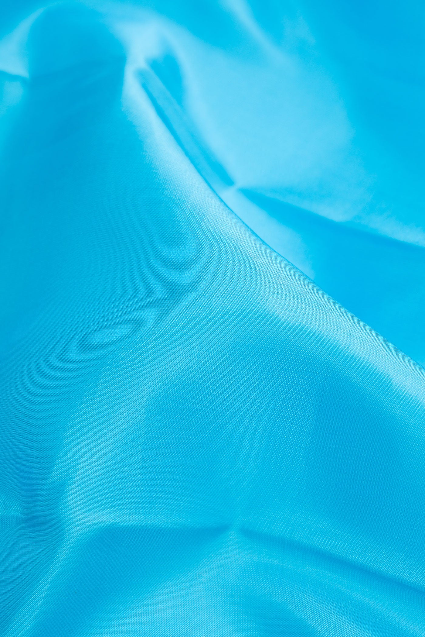 Close up of Sky Blue Dual Tone Kanchipuram Silk Saree with Plain Body and Temple Border.  displaying folds