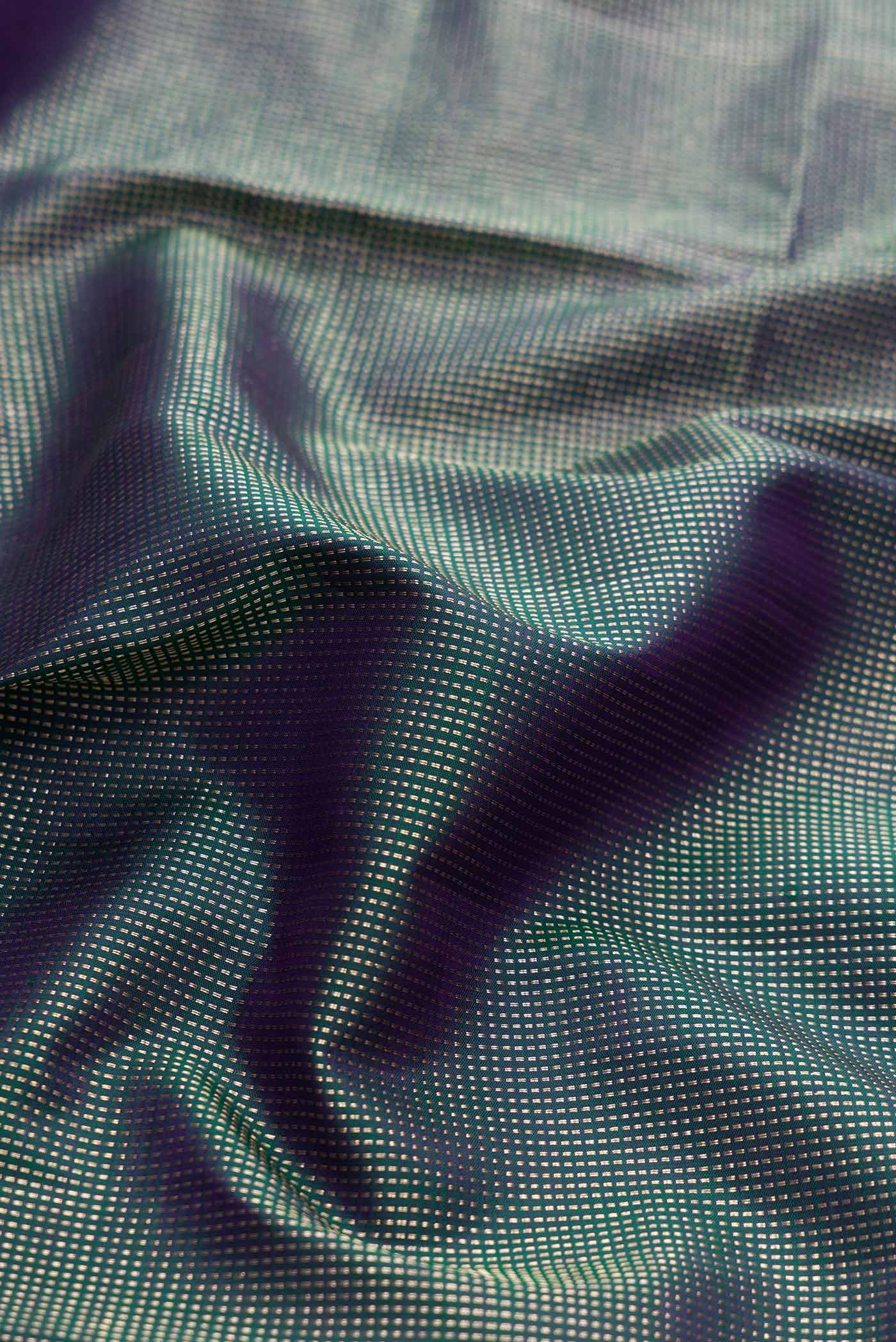 Close up of Peacock Blue Dual Tone Kanchipuram Silk Saree with Zari Brocade on the body and Fancy Border displaying folds