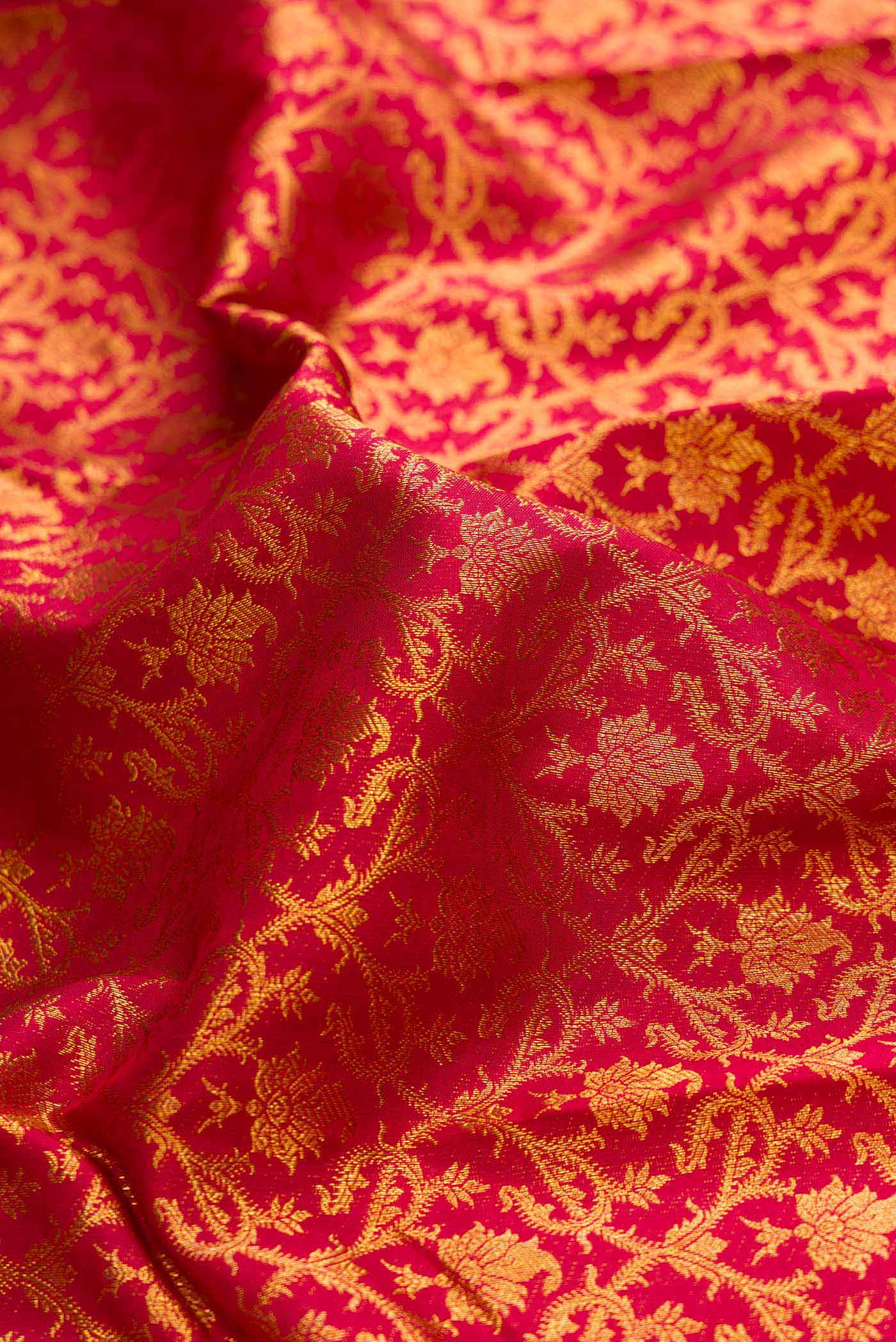Close up of Maroon Dual Tone Kanchipuram Saree with Zari Brocade on the body and Zari Border displaying folds