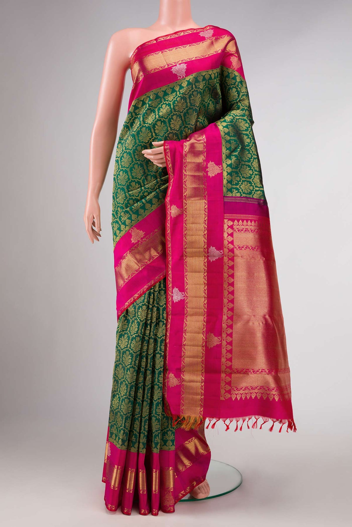 Pure Silk Pure Zari Green Dual Tone Kanchipuram Saree with Zari Brocade on the body and Zari Border displayed on a mannequin