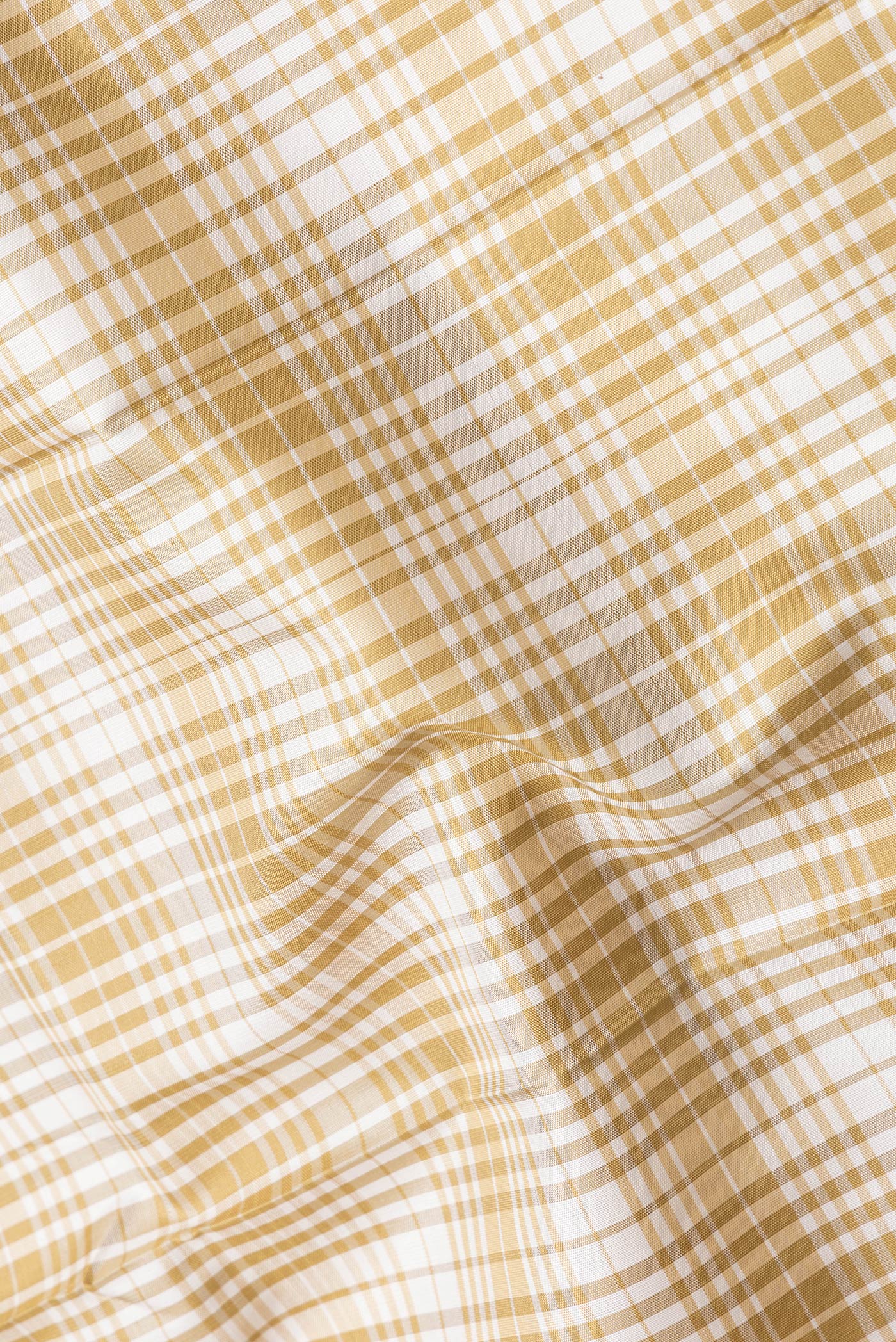 Close up of Beige Dual Tone Kanjivaram Silk Saree with Checked design on the body and Zari Border.  displaying folds