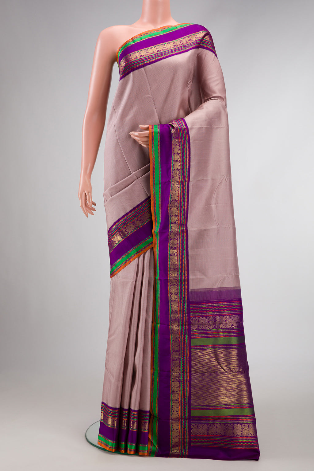 Pure Silk Pure Zari Brown Dual Tone Kanchipuram Saree with Stripes on the body and Zari And Thread Border.  displayed on a mannequin