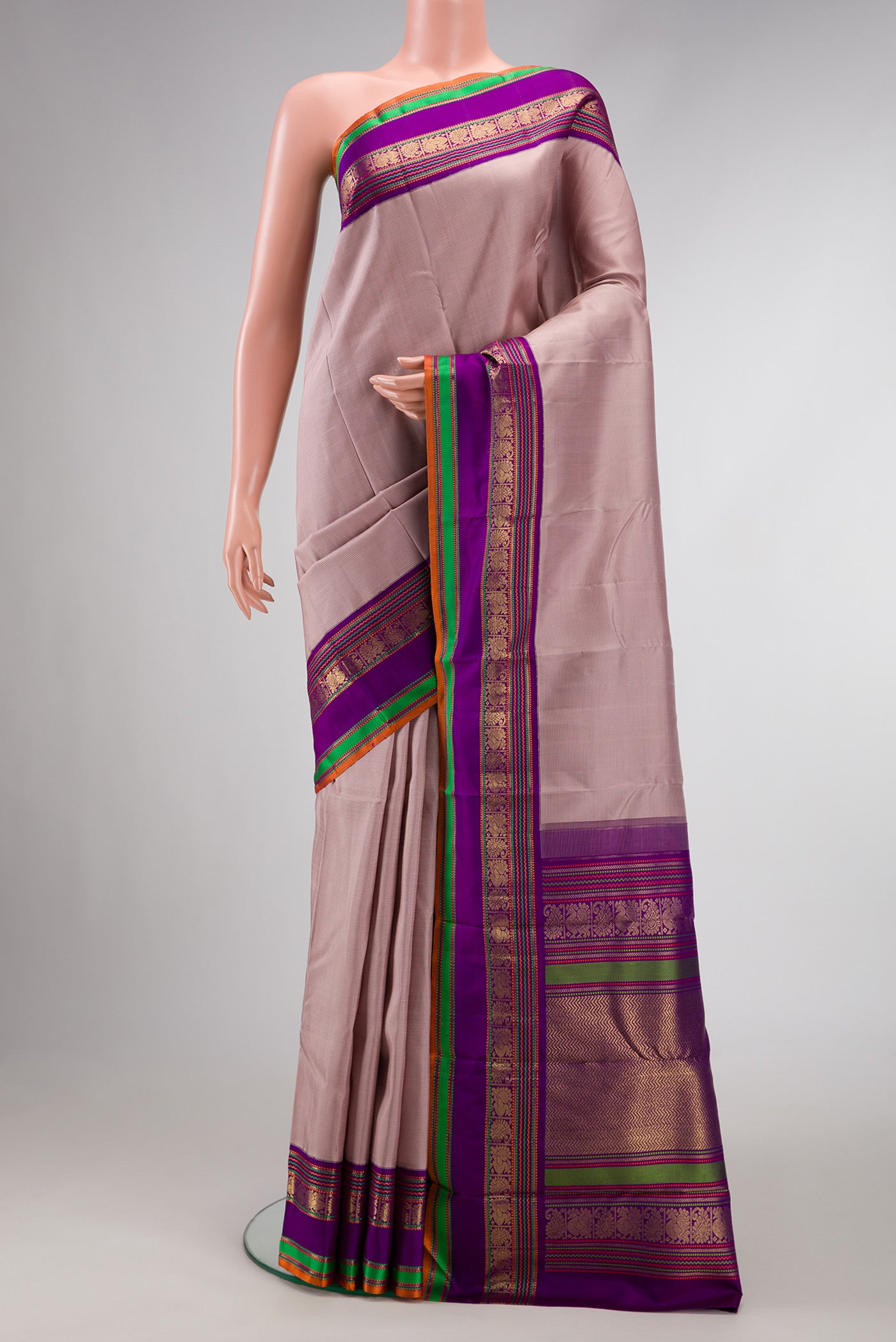 Pure Silk Pure Zari Brown Dual Tone Kanchipuram Saree with Stripes on the body and Zari And Thread Border.  displayed on a mannequin