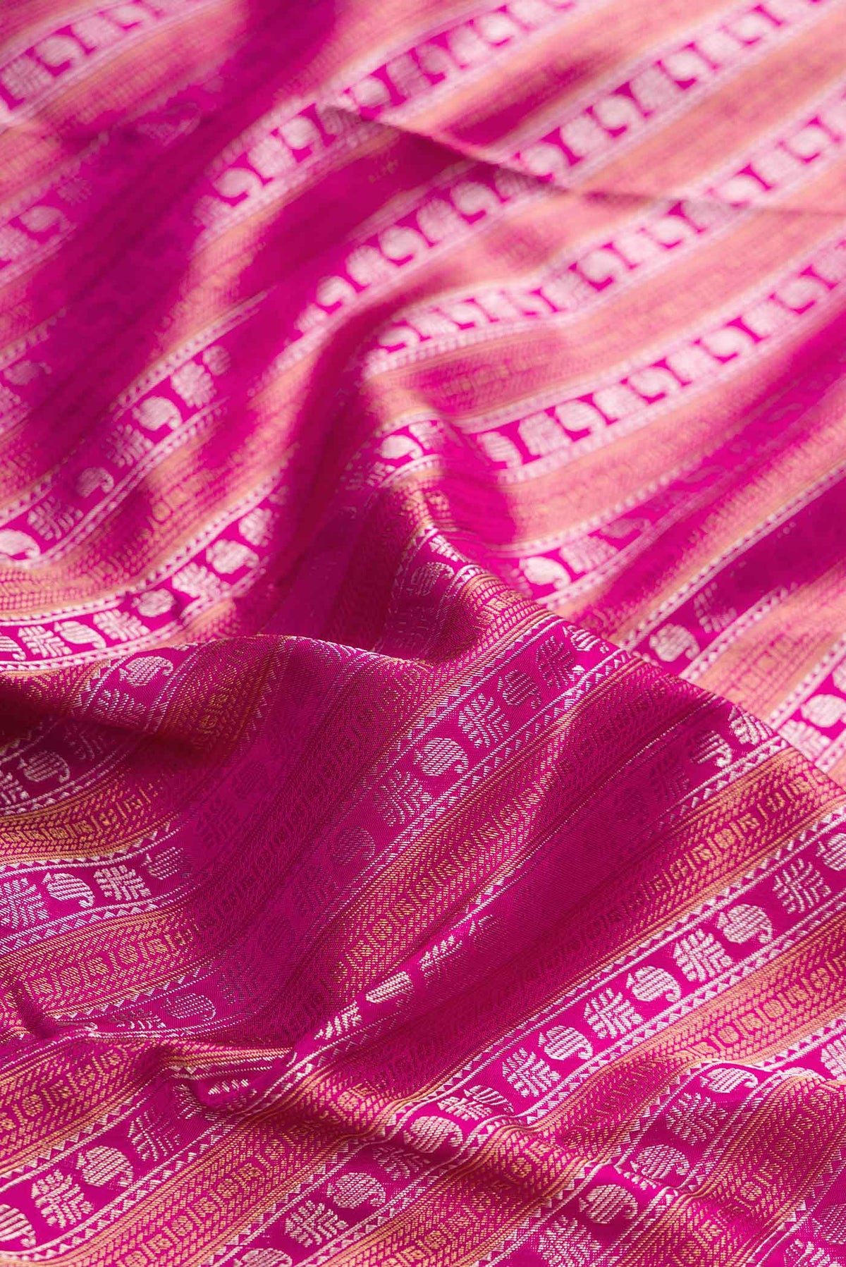 Close up of Pink Dual Tone Kanchipuram Silk Saree with Zari Brocade on the body and Zari Border displaying folds