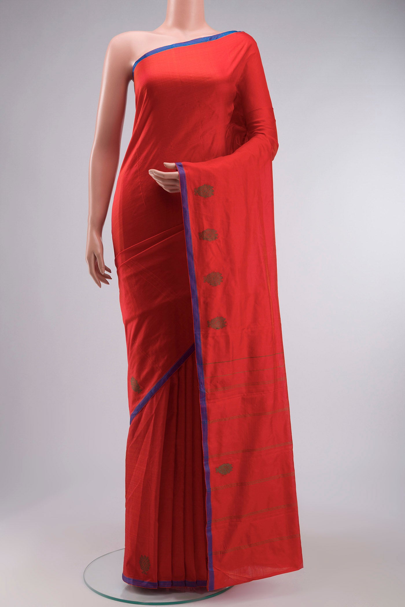Orange Kanchipuram Silk Saree with Plain Body and Thread Border displayed on a mannequin