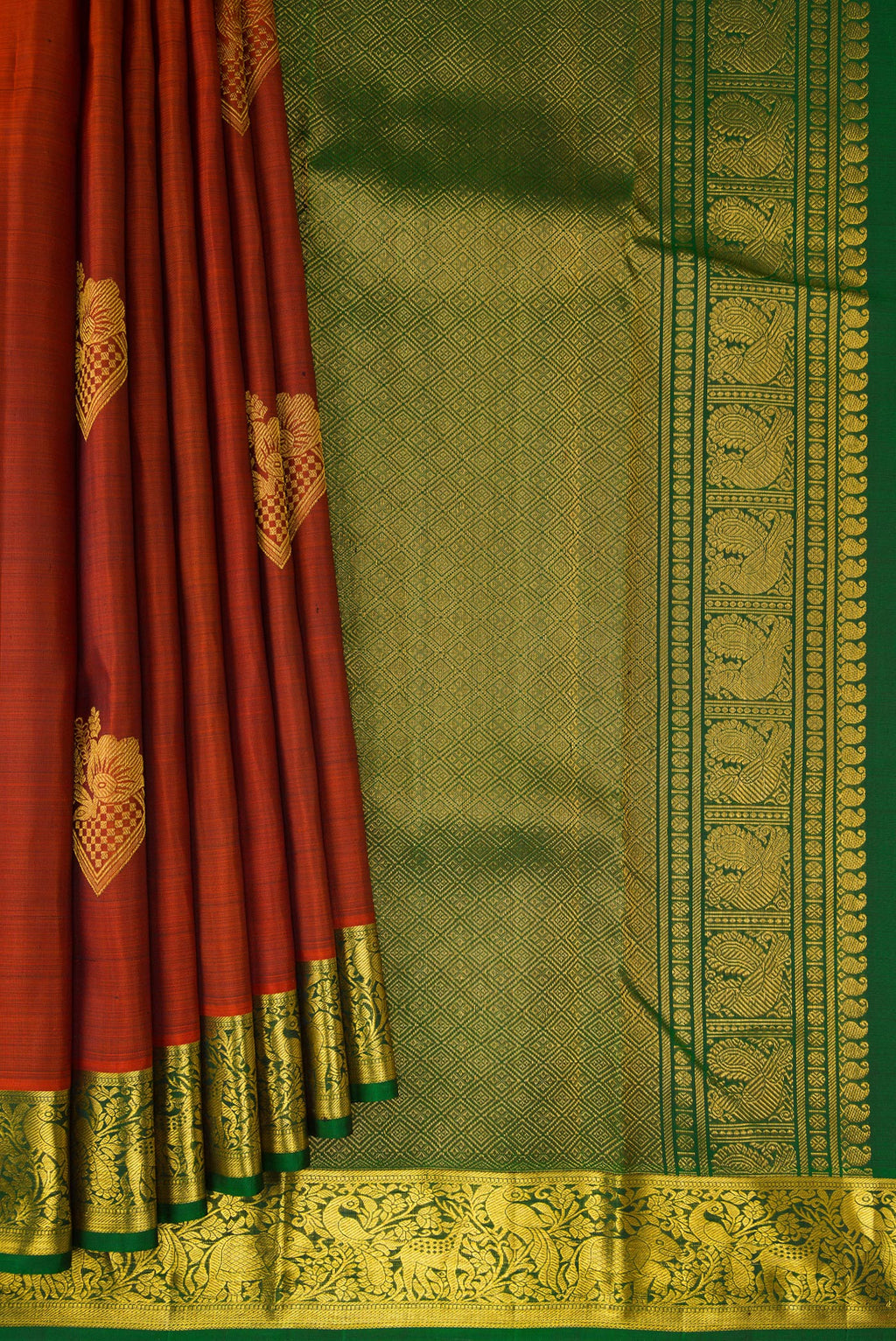 Pleats and pallu of Brick Orange Kanjivaram Silk Saree with Zari Butta on the body and Zari Border. 