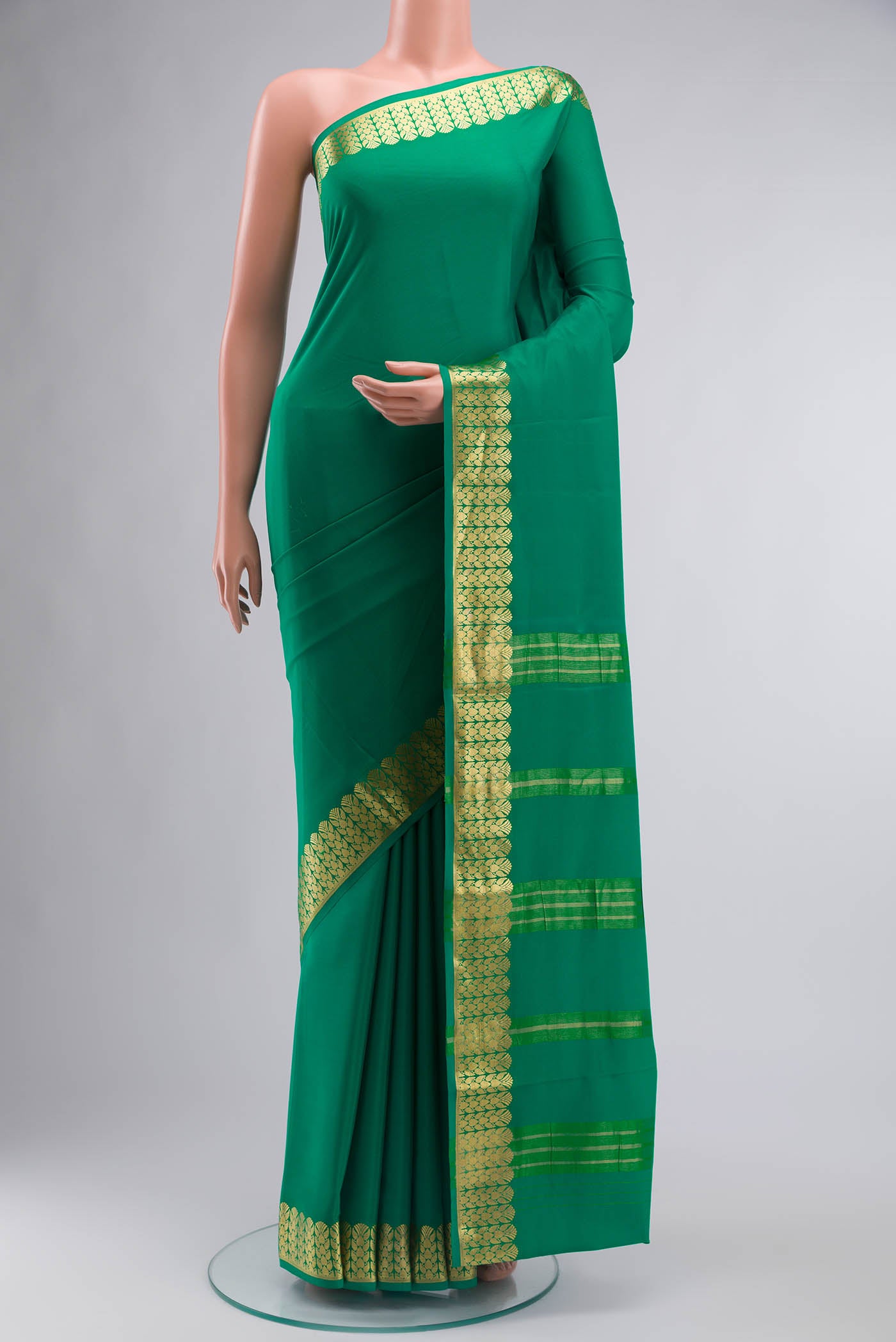 Green Mysore Crepe Saree with Plain Body and Zari Border displayed on a mannequin