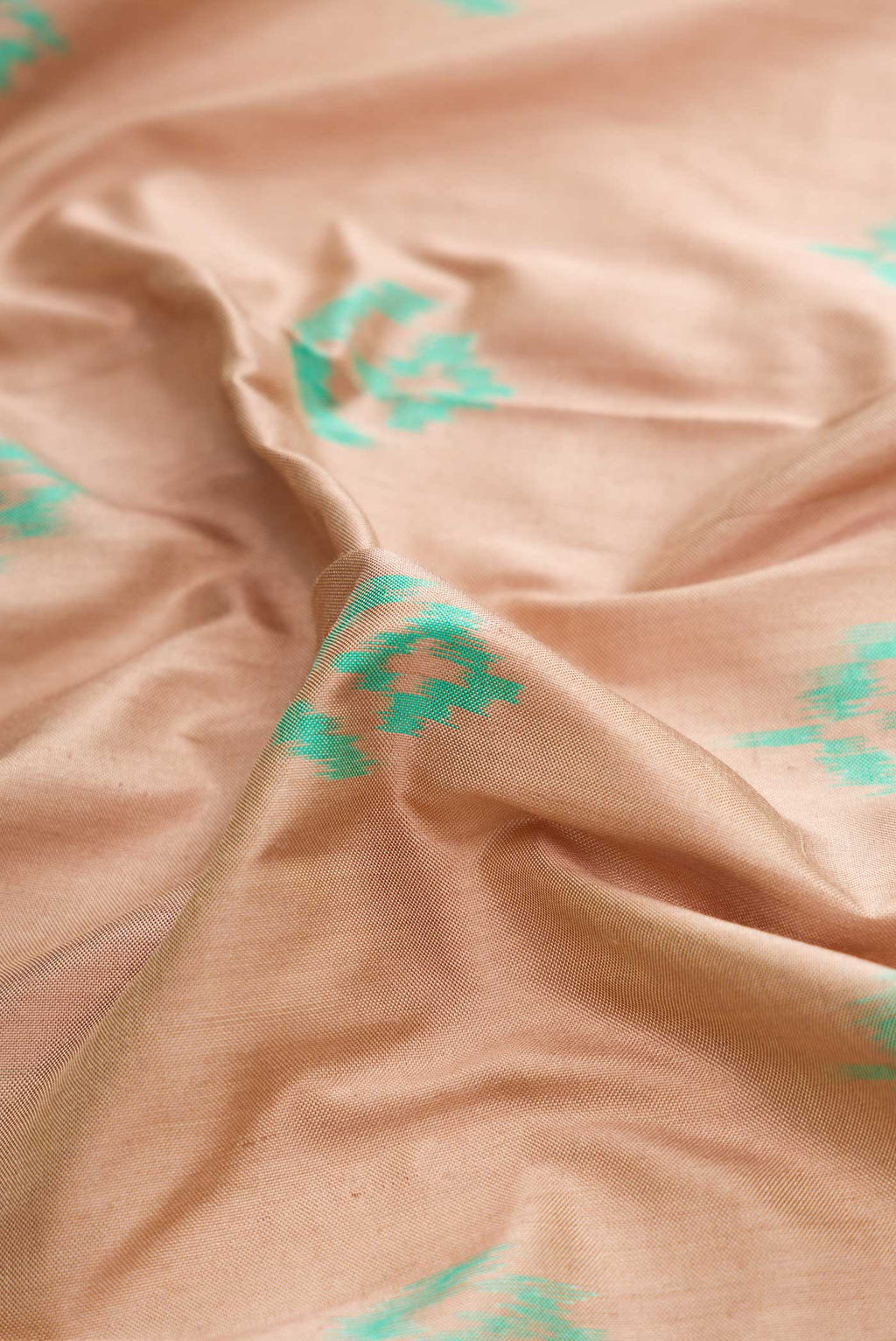 Close up of Brown Dual Tone Double Ikat Saree with Ikat Print on the body and Ikat Border displaying folds