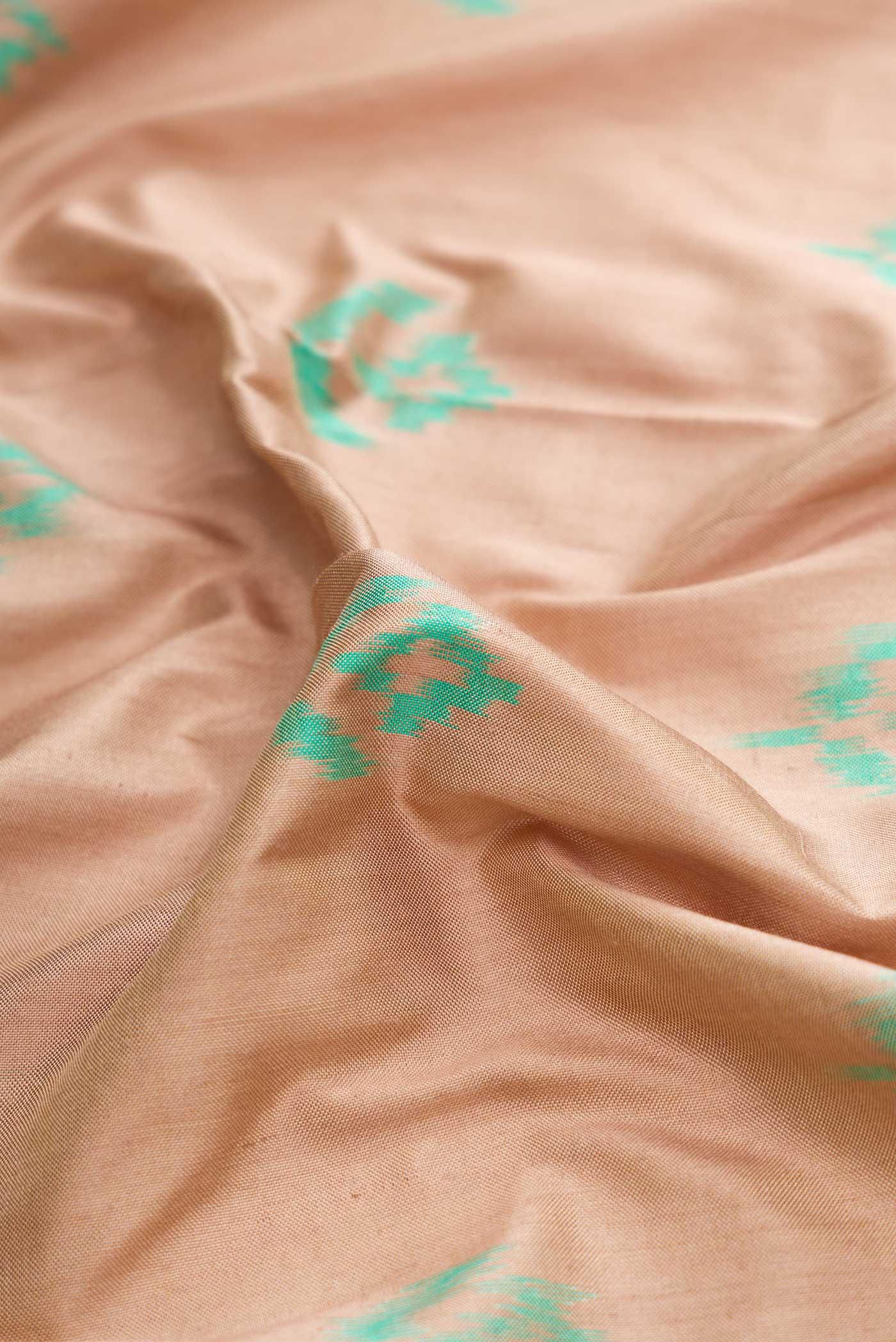 Close up of Brown Dual Tone Double Ikat Saree with Ikat Print on the body and Ikat Border displaying folds