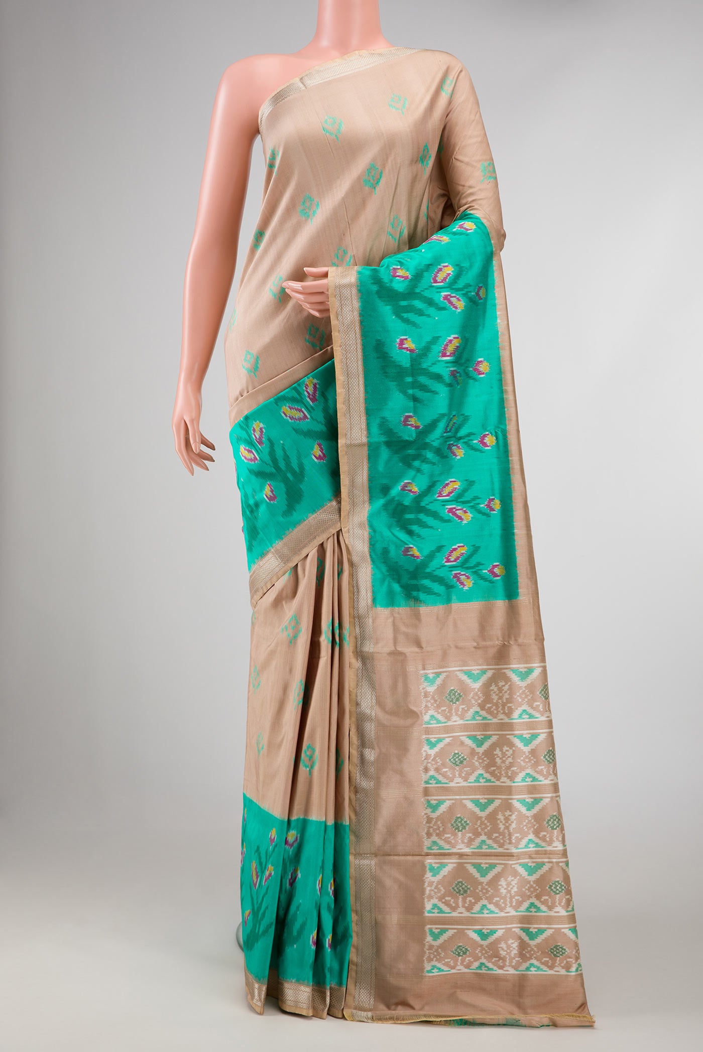 Brown Dual Tone Double Ikat Saree with Ikat Print on the body and Ikat Border displayed on a mannequin
