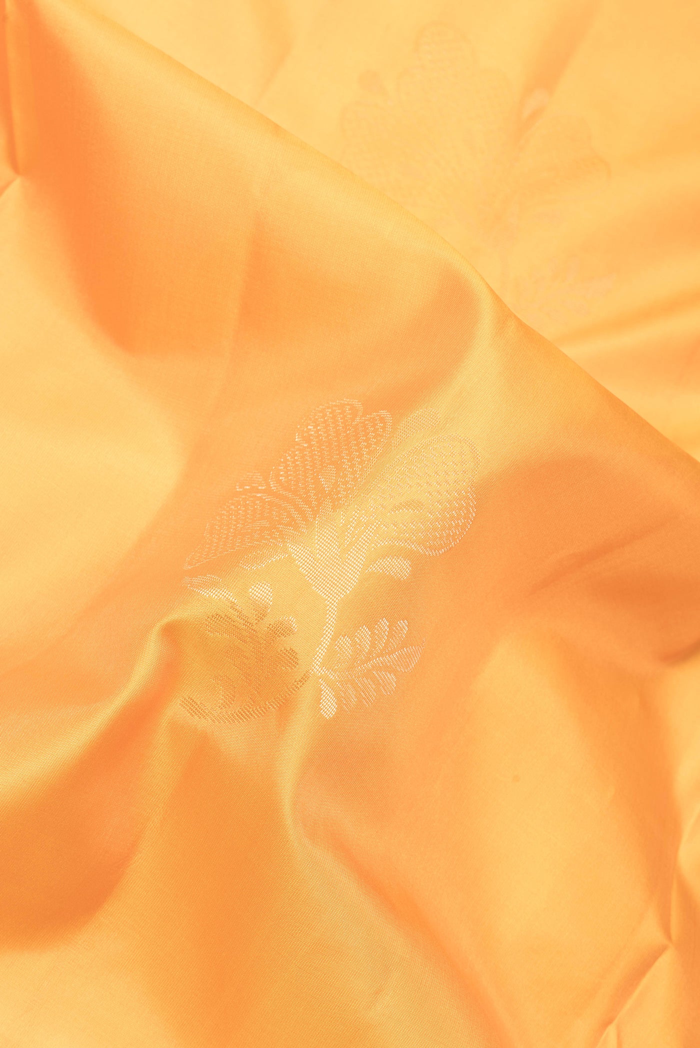 Close up of Yellow Soft Silk Saree with Zari Butta on the body and Plain Border.  displaying folds