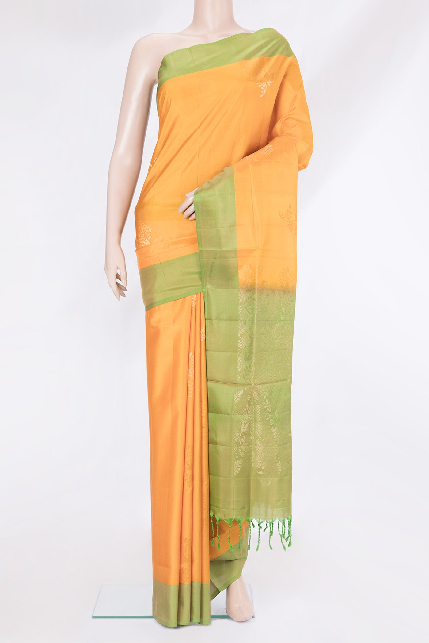 Yellow Soft Silk Saree with Zari Butta on the body and Plain Border.  displayed on a mannequin