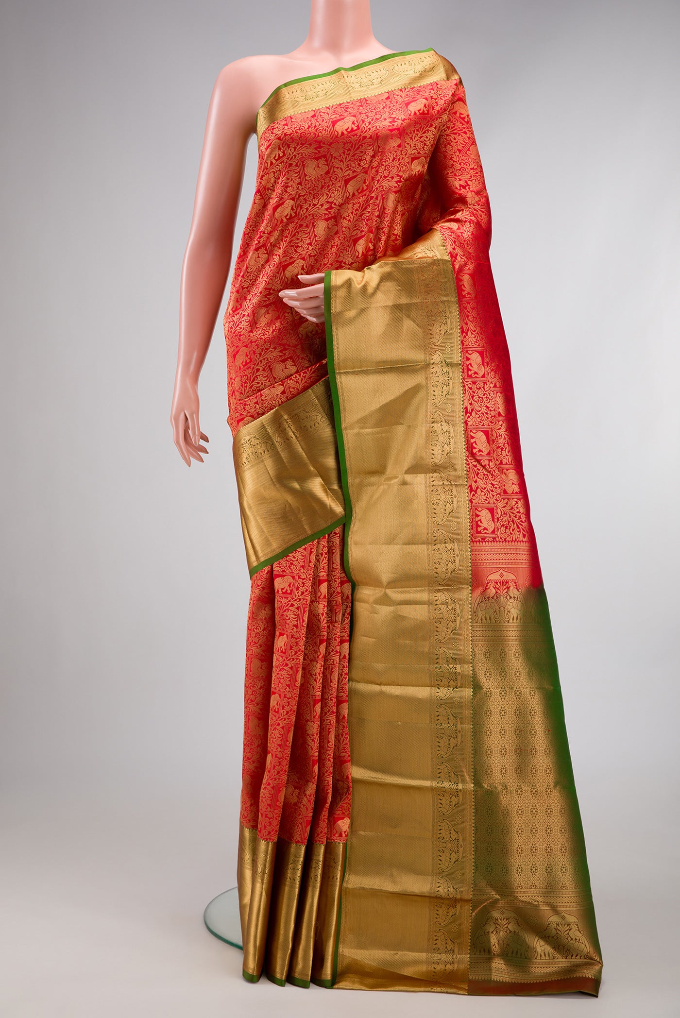 Red Kanchipuram Silk Saree with Zari Brocade on the body and Zari Border.  displayed on a mannequin