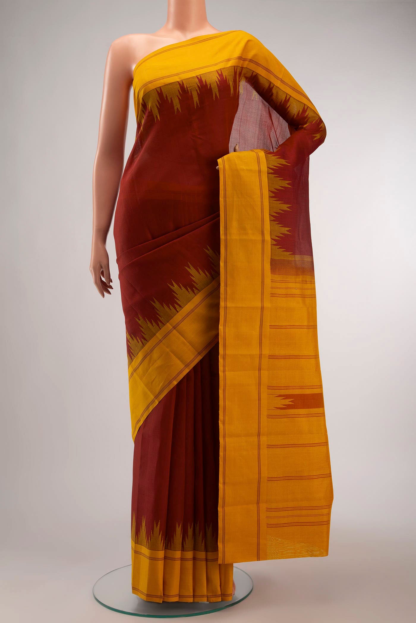Maroon Kanchi Cotton Saree with Plain Body and Plain Border displayed on a mannequin
