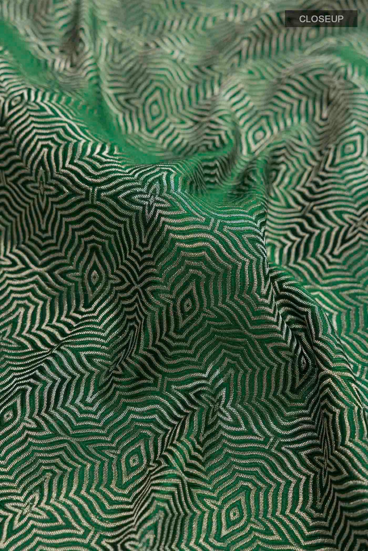 Close up of Green Mysore Crepe Saree with Zari Brocade on the body and Zari Border displaying folds