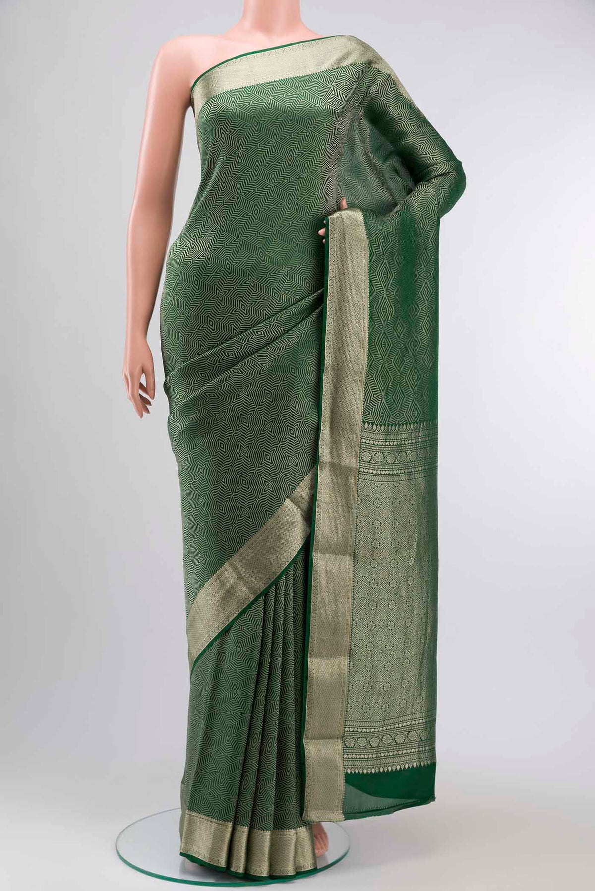 Green Mysore Crepe Saree with Zari Brocade on the body and Zari Border displayed on a mannequin