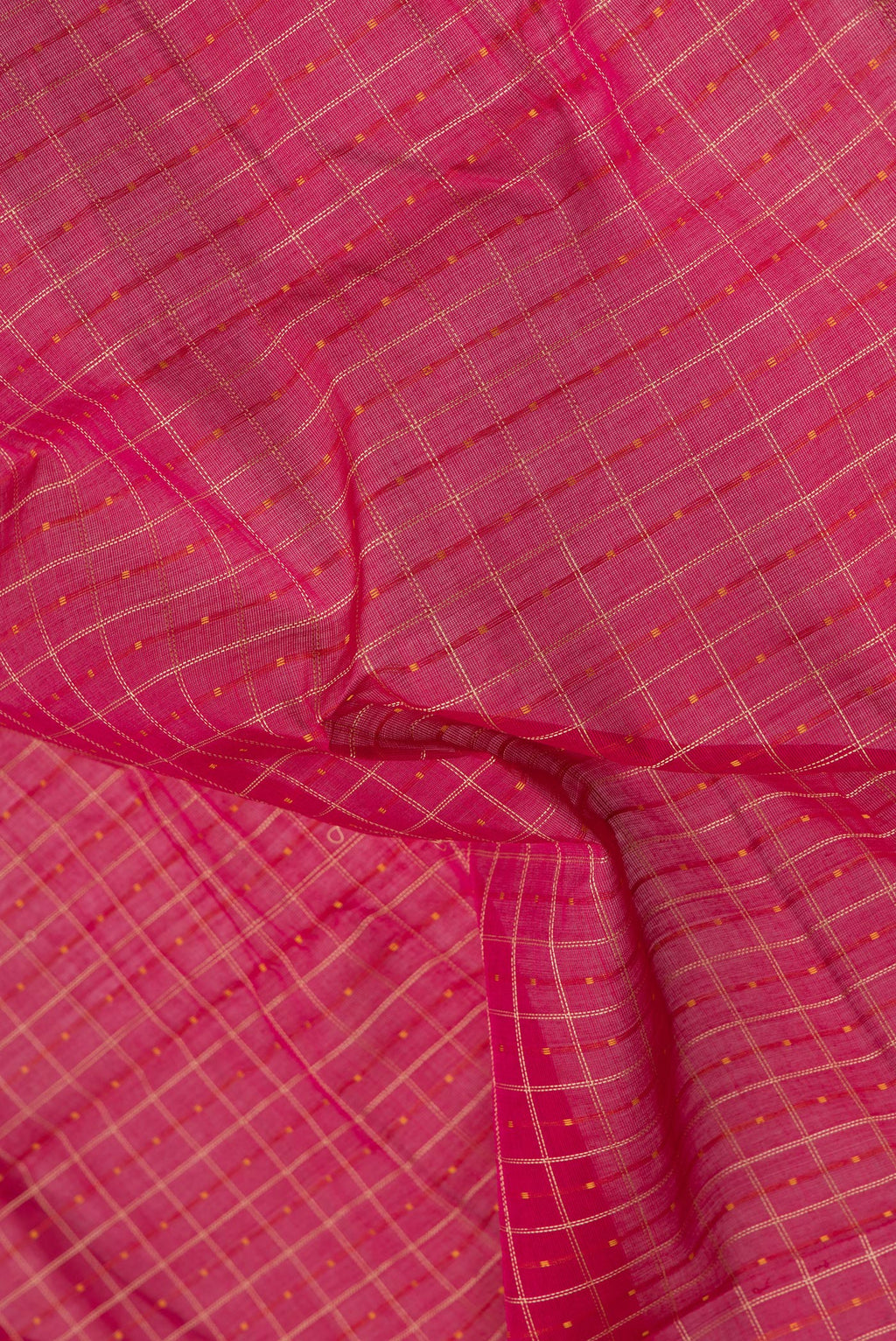 Close up of Pink Kanchi Cotton Saree with Checked design on the body and Zari Border.  displaying folds