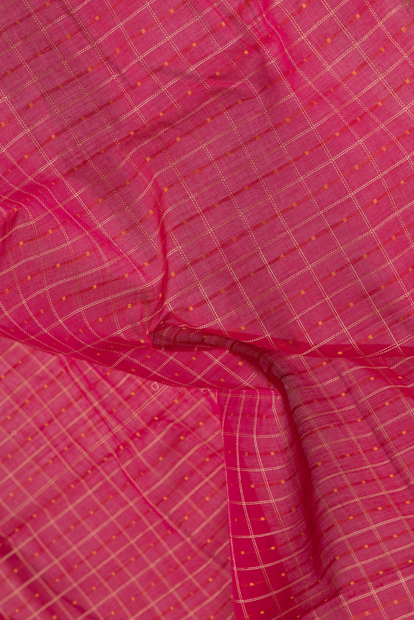 Close up of Pink Kanchi Cotton Saree with Checked design on the body and Zari Border.  displaying folds
