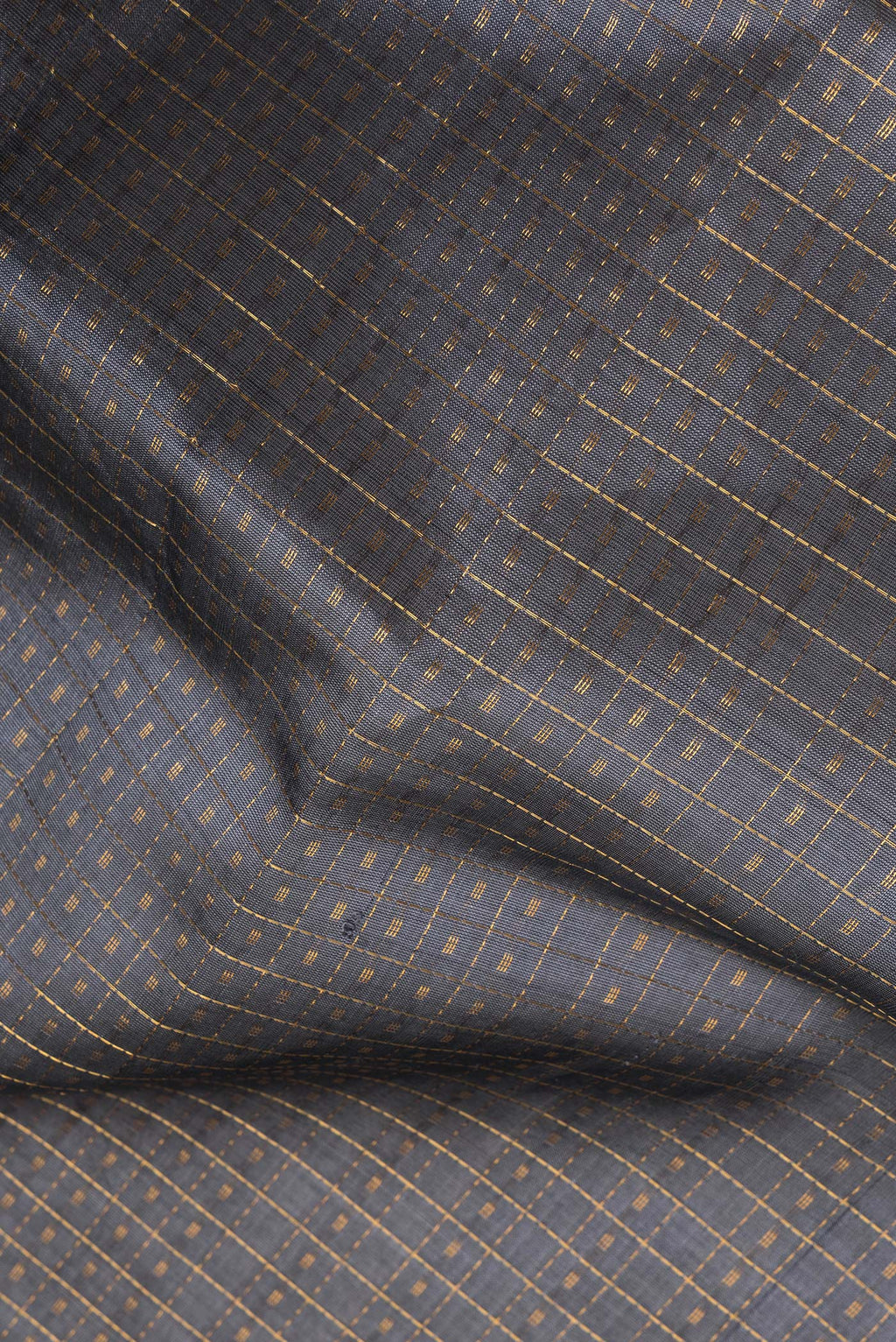 Close up of Grey Silk Cotton Saree with Checked design on the body and Zari Border.  displaying folds