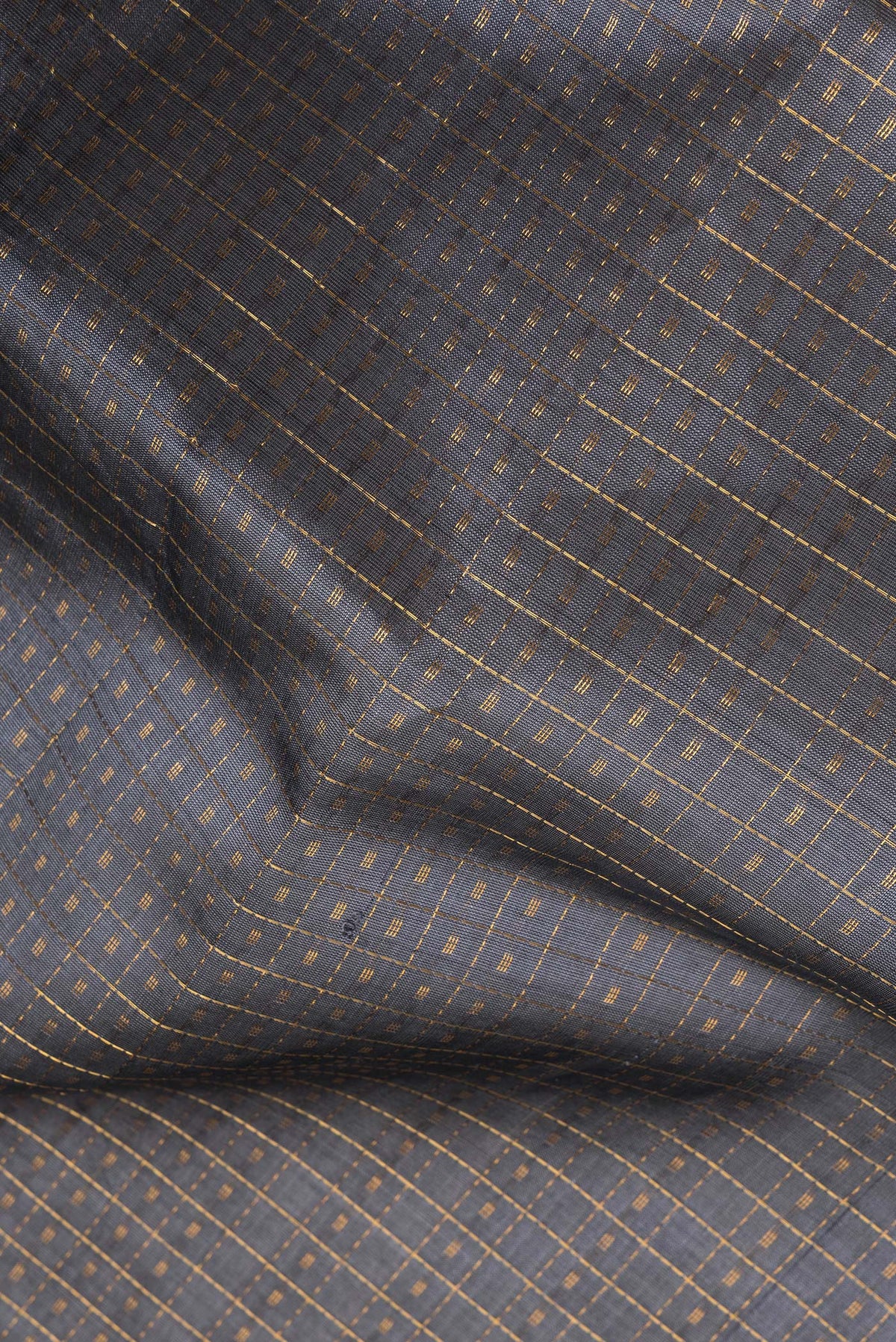 Close up of Grey Silk Cotton Saree with Checked design on the body and Zari Border.  displaying folds