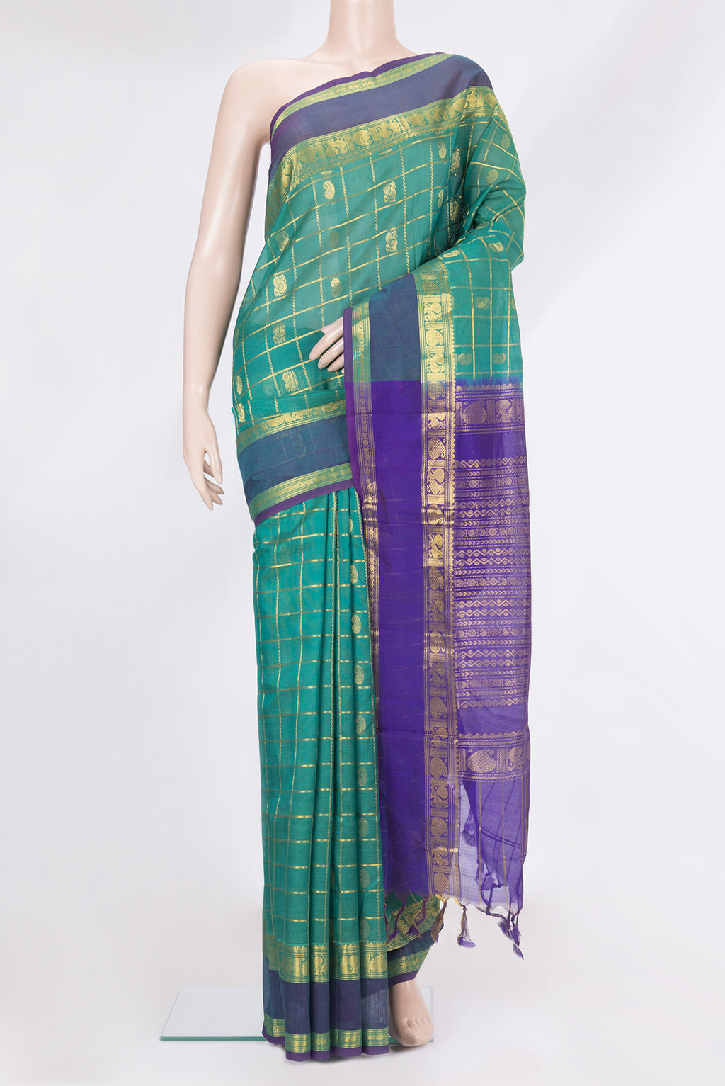 Green Silk Cotton Saree with Checked design on the body and Zari Border.  displayed on a mannequin